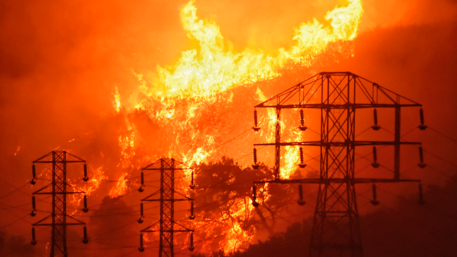 REPORT - In this December 16, 2017 photo provided by the Santa Barbara County Fire Department, flames are burning near power lines in Sycamore Canyon, near West Mountain Drive, Montecito, California. An investigation has determined that one of the largest and most destructive fires in California's history have been caused by power lines coming into contact in high winds. The Ventura County Fire Department announced on Wednesday, March 13, 2019 that the power lines in Southern California to Edison came into contact with a dry brush on December 4, 2017, and had finally blackened more than 440 square kilometers (1 139 square kilometers). (Mike Eliason / Santa Barbara County Fire Department via AP, File)