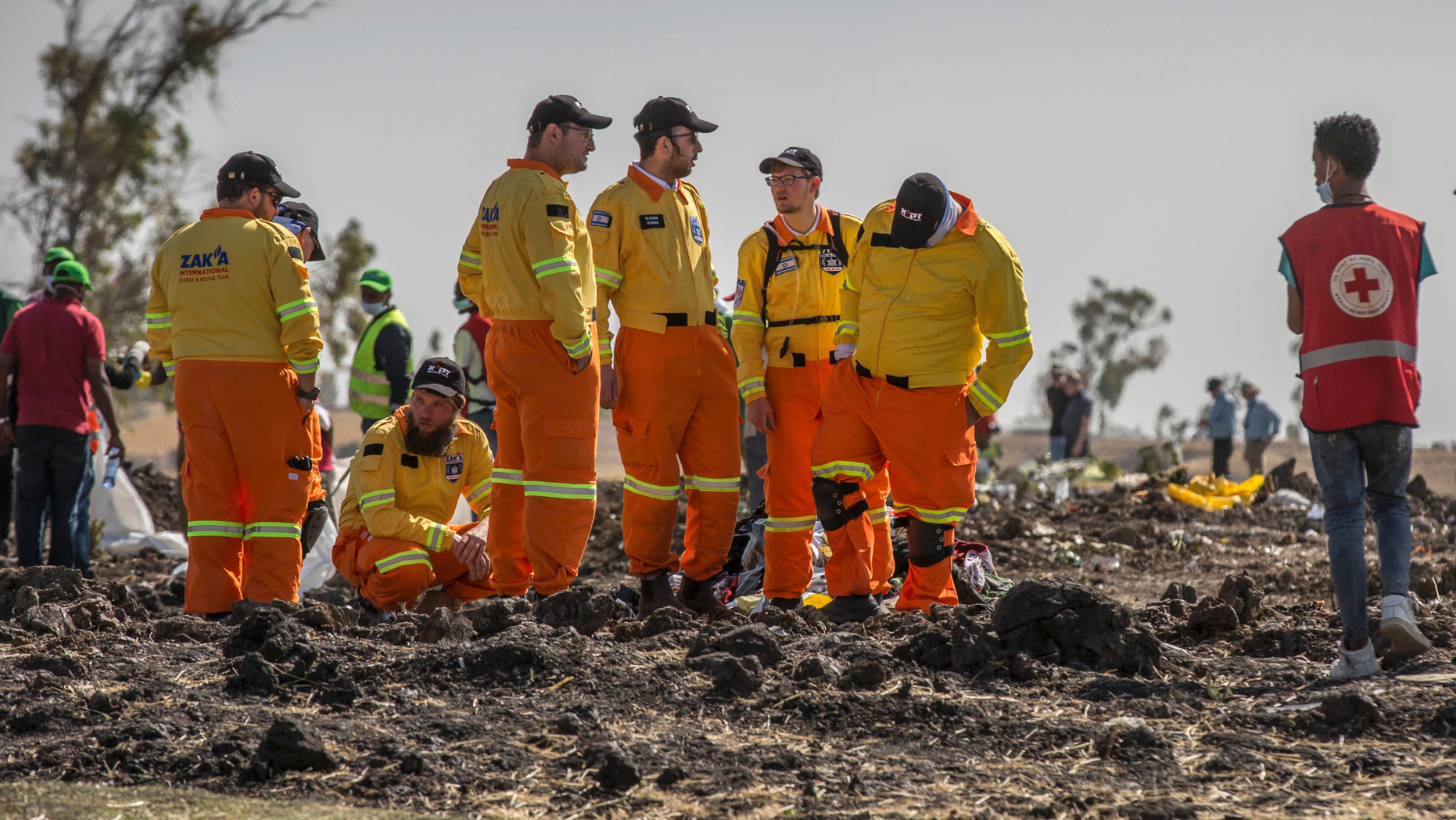 Investigators from Israel examine wreckage at the scene where the Ethiopian Airlines Boeing 737 Max 8 crashed shortly after takeoff on Sunday killing all 157 on board, near Bishoftu, or Debre Zeit, south of Addis Ababa, in Ethiopia Tuesday, March 12, 2019. Ethiopian Airlines had issued no new updates on the crash as of late afternoon Tuesday as families around the world waited for answers, while a global team of investigators began picking through the rural crash site. (AP Photo/Mulugeta Ayene)