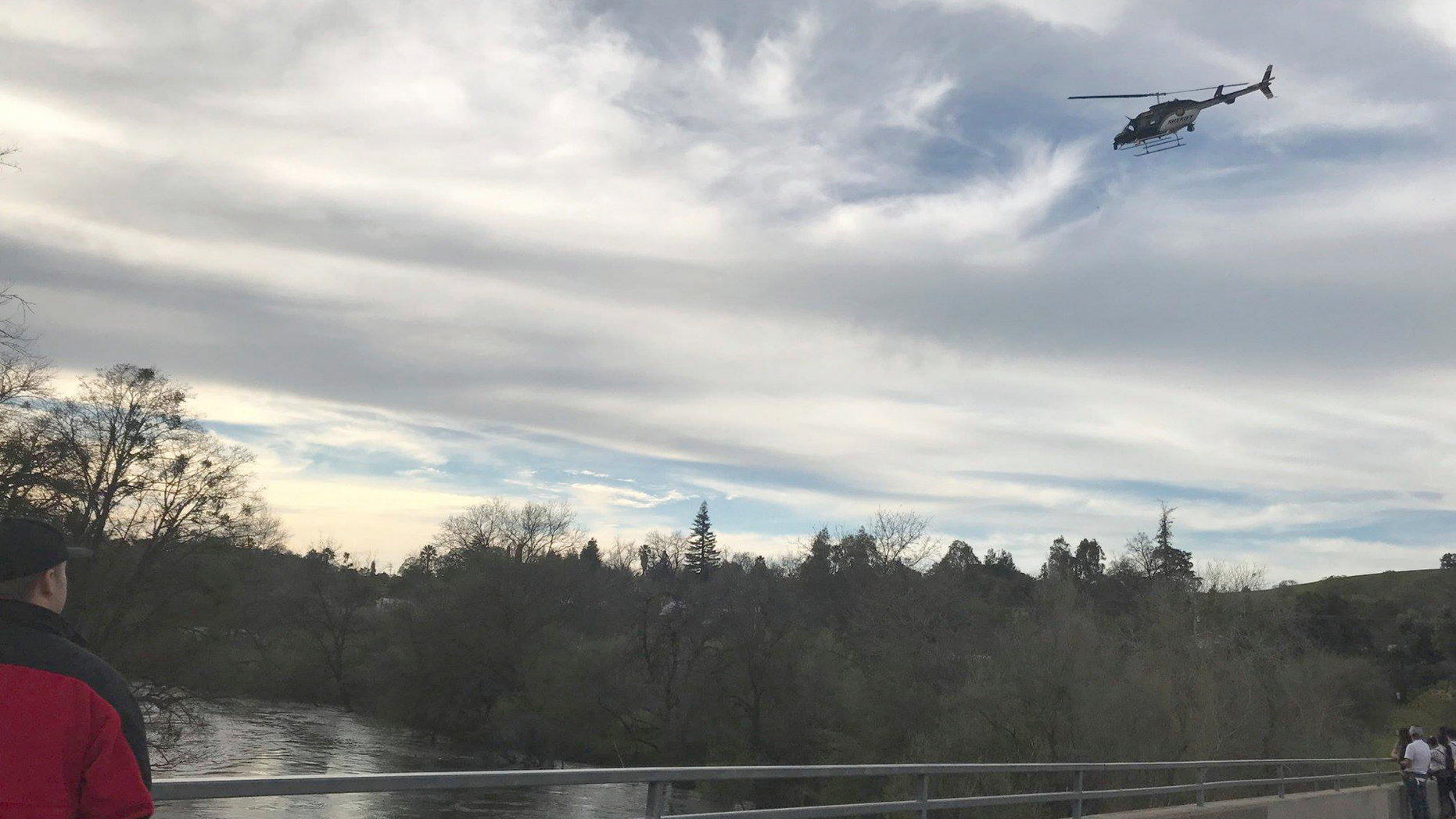 In this Sunday, March 17, 2019 photo provided by the Stanislaus Consolidated Fire Protection District Authorities, fire and rescue personnel search for a 5-year-old girl who was swept away by a swollen river in Central California. The Stanislaus Sheriff's Department said the girl slipped off rocks and fell into the Stanislaus River Sunday afternoon. The department said several relatives and bystanders tried to rescue her but couldn't reach her. The department said in a statement crews on boat and a helicopter searched until darkness Sunday but called off their search because of the river's dangerous conditions. (Stanislaus Consolidated Fire Protection District via AP)