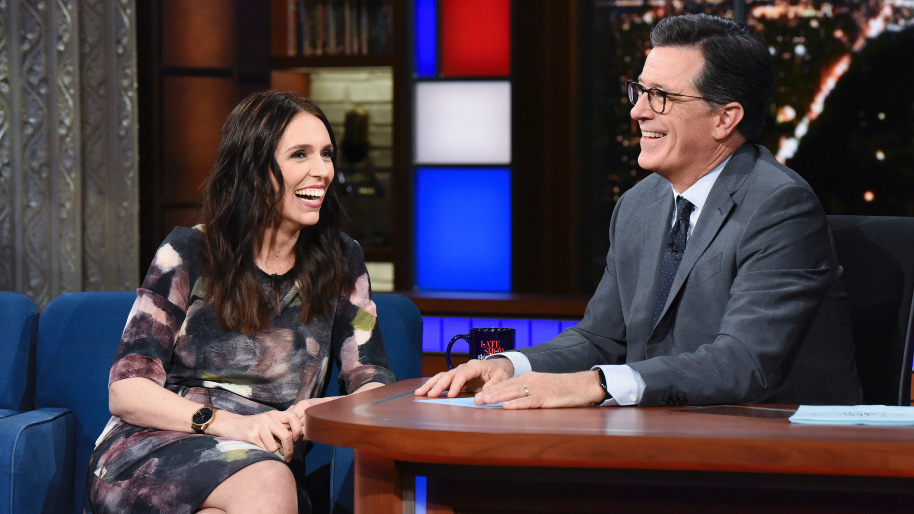 This Sept. 26, 2018 photo release by CBS shows New Zealand Prime Minister Jacinda Ardern, left, with host Stephen Colbert during a taping of "The Late Show with Stephen Colbert," in New York. Colbert has postponed what was supposed to be a surprise visit to New Zealand following the terrorist attack in Christchurch that killed 50 people. Colbert’s The top-rated American late-night show said that he was supposed to travel to New Zealand on Wednesday for a week of shows. He was invited last fall when Ardern was a guest on the show.