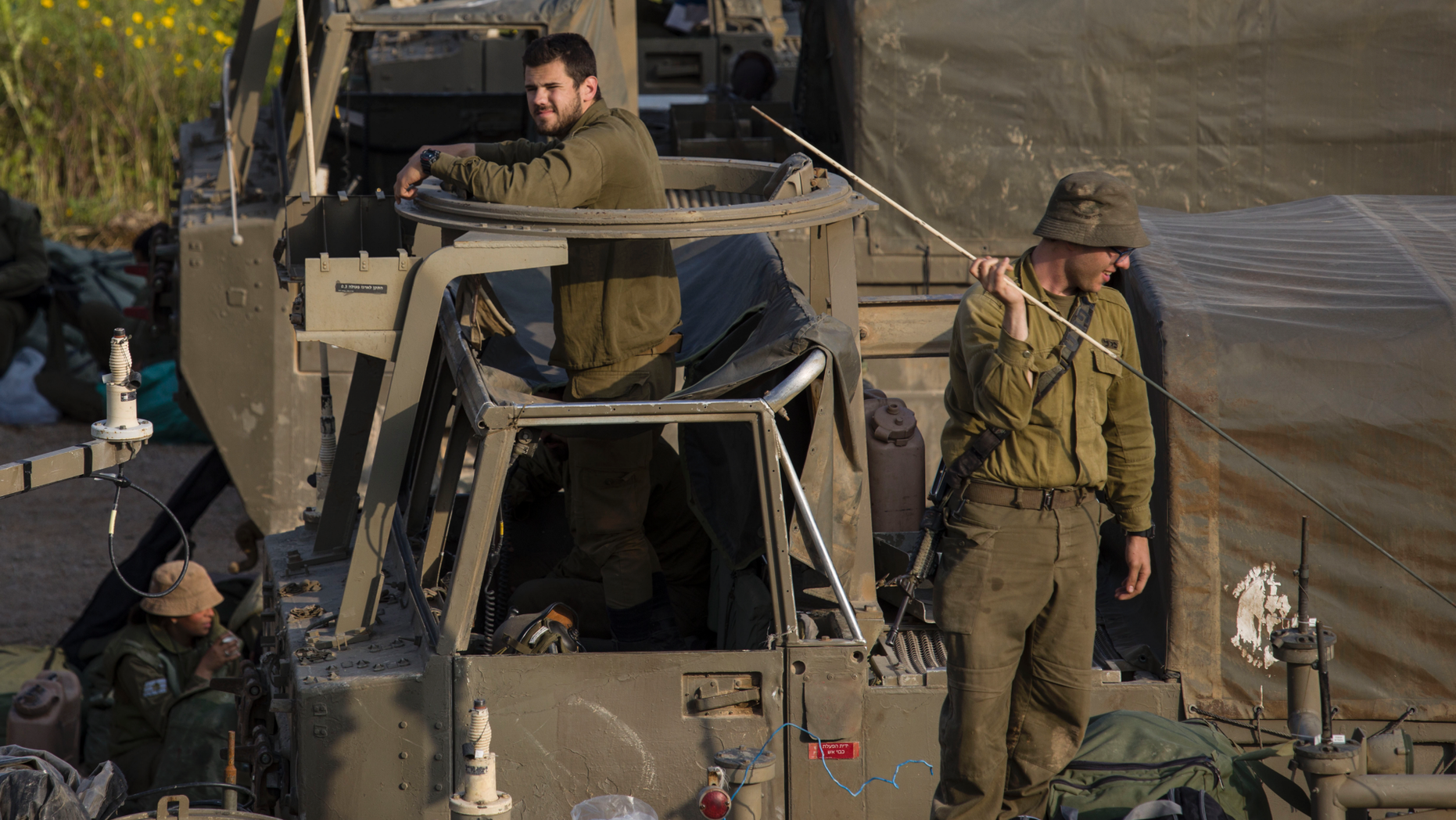 Israeli soldiers sit on top of mobile artillery near the border with Gaza, in southern Israel, Wednesday, March 27, 2019. (AP Photo/Tsafrir Abayov)