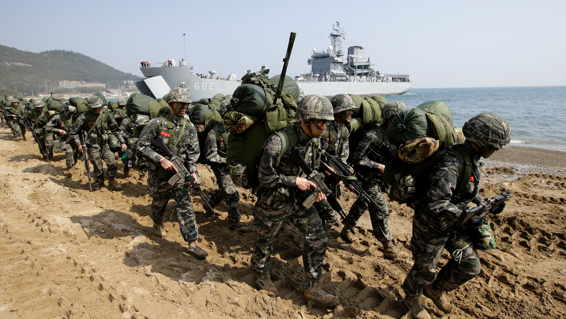 FILE - In this March 30, 2015, file photo, South Korean Marines march after landing on the beach during the U.S.-South Korea joint landing military exercises as a part of the annual joint military exercise Foal Eagle between South Korea and the United States in Pohang, South Korea. South Korea and the U.S. say they've decided to end their springtime military drills to back diplomacy with North Korea. (AP Photo/Lee Jin-man, File)