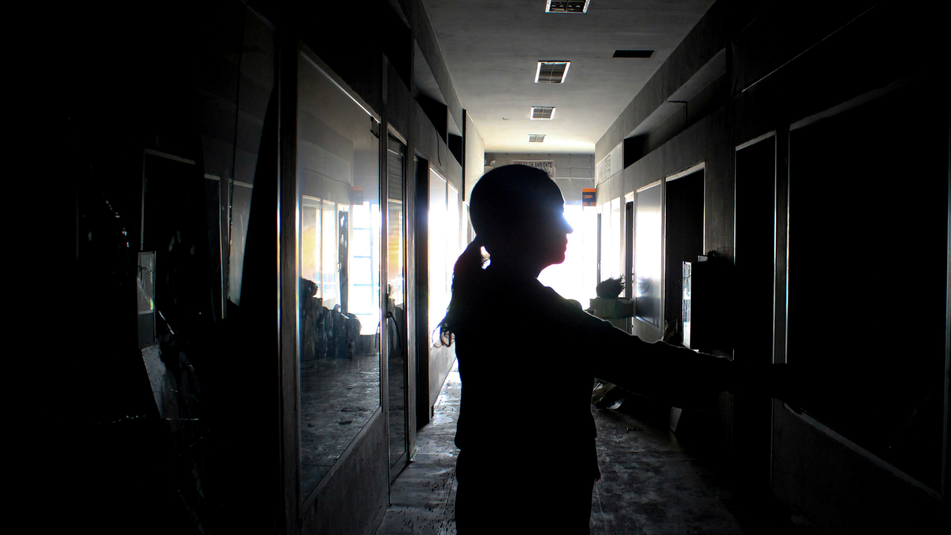 A mall employe inspects stores one day after the mall was looted, in Maracaibo, Venezuela, Wednesday, March 13, 2019. Venezuela's largest private food supplier says massive looting and vandalism occurred at four facilities in the city of Maracaibo during nationwide power outages, complicating efforts to distribute food and drinks to people in the area. (AP Photo/Henry Chirinos)