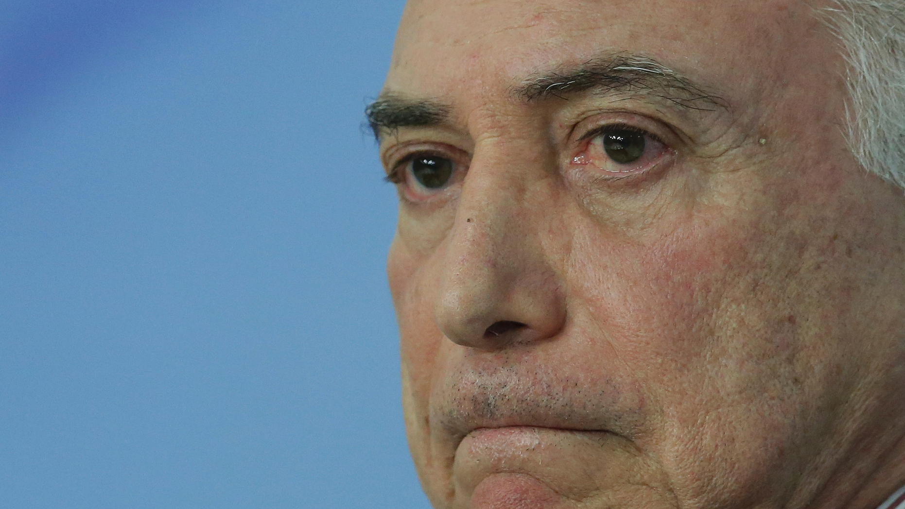 FILE - In this June 1, 2018 file photo, Brazil's President Michel Temer pauses during a speech at the Planalto Presidential Palace, in Brasilia, Brazil. A judge in Rio de Janeiro issued an arrest warrant Thursday, March 21, 2019, for the former president, who is being investigated in several corruption cases. (AP Photo/Eraldo Peres, File)