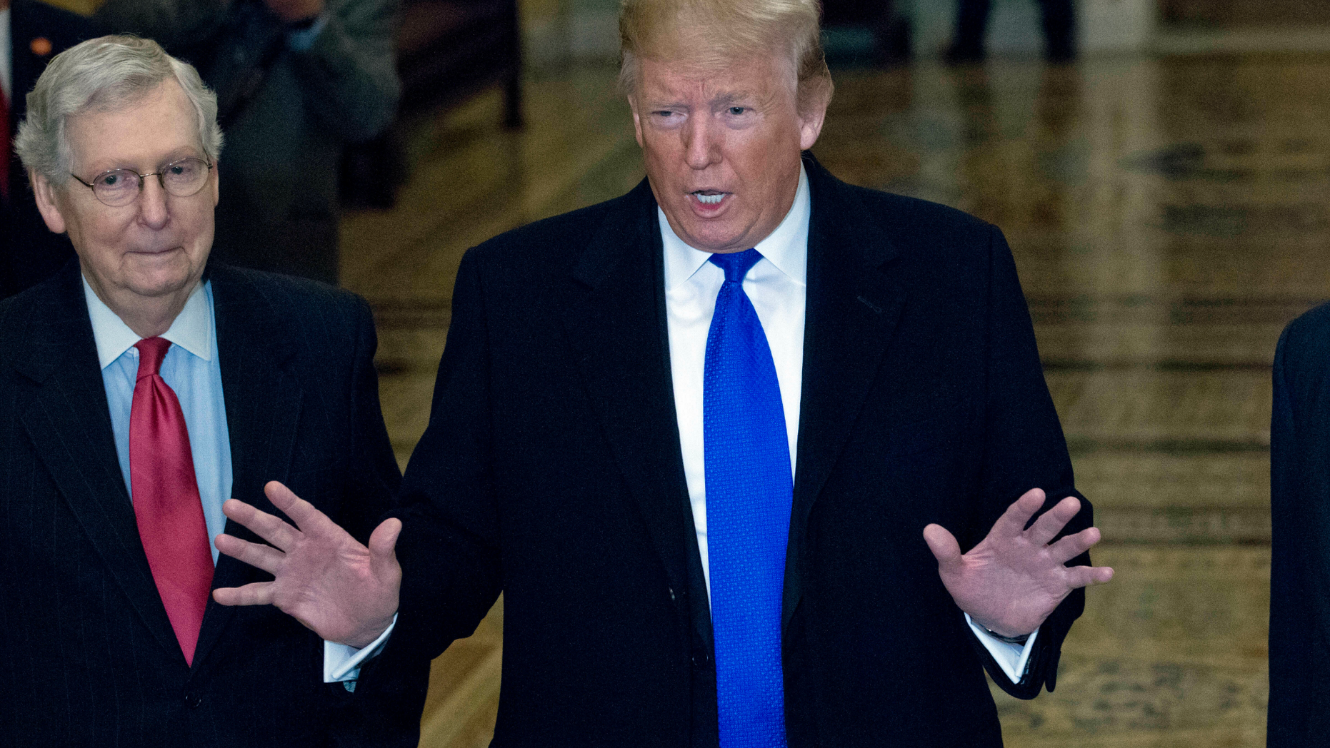 President Donald Trump accompanied by Senate Majority Leader Mitch McConnell of Ky., left, arrives for a Senate Republican policy lunch on Capitol Hill in Washington, Tuesday, March 26, 2019. (AP Photo/Jose Luis Magana)