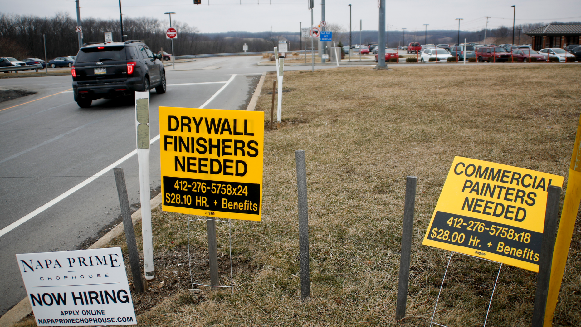 In this Friday, March 1, 2019, photo signs for employment opportunities are posted at an exit ramp off of Interstate 79 in Zelienople, Pa. Small business hiring slowed dramatically in February, a sign that company owners may be getting cautious about the economy. That report comes from payroll provider ADP, which said Wednesday, March 6, that its customers with up to 49 staffers added just 12,000 jobs last month, down sharply from 107,000 in January and 84,000 in December. (AP Photo/Keith Srakocic)