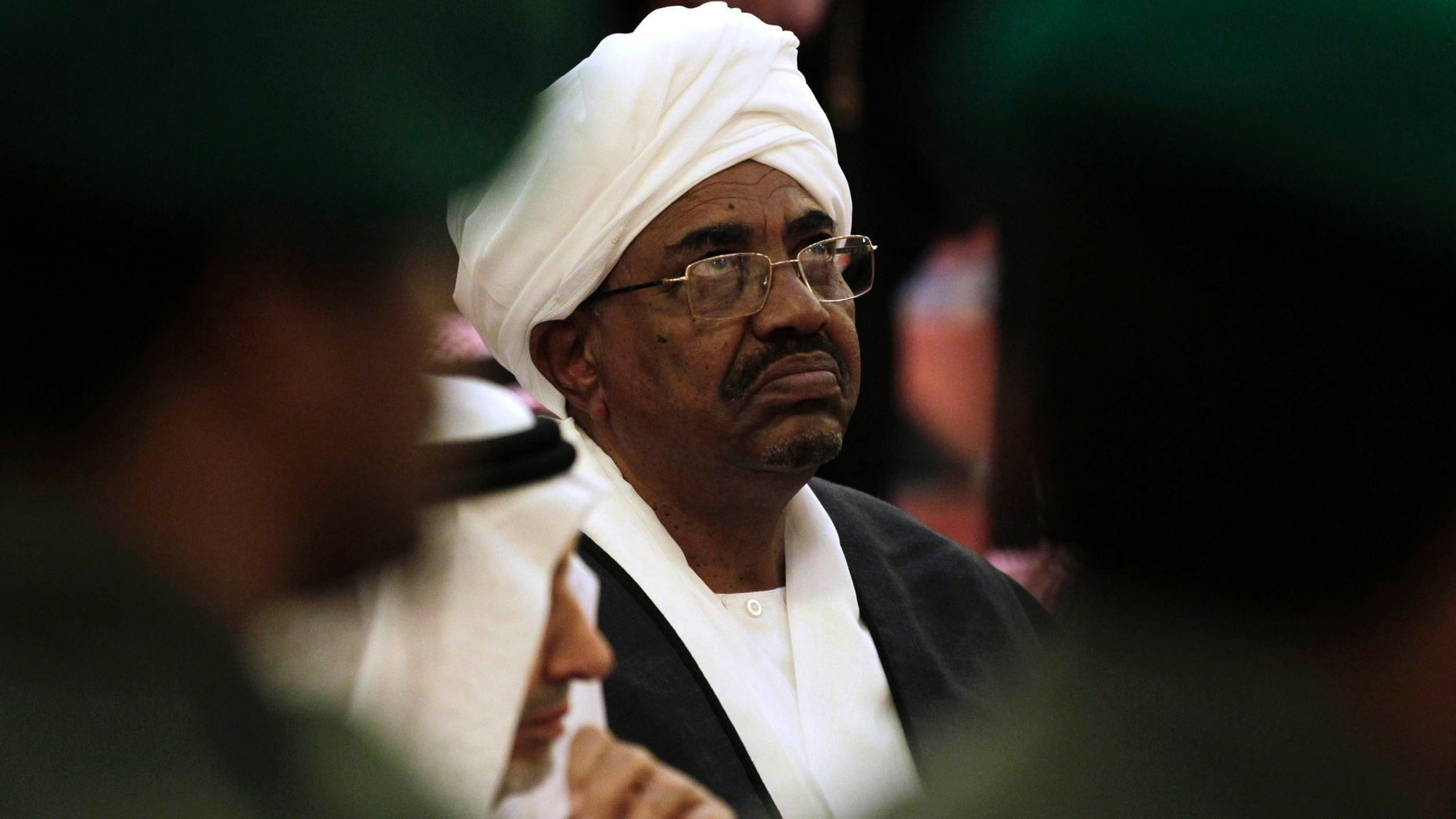 FILE - In this Oct. 25, 2011 file photo, Sudanese President Omar al-Bashir attends the funeral of Saudi Crown Prince Sultan bin Abdul-Aziz Al Saud, in Riyadh, Saudi Arabia. In a report issued Tuesday, March 27, 2019, New York-based Human Rights Watch described al-Bashir as a "fugitive from international justice" because he is wanted by the International Criminal Court for charges of genocide linked to the Darfur conflict. The rights group urged Tunisia to either "bar or arrest" Sudanese President Omar al-Bashir if he tries to attend an Arab League summit this weekend. (AP Photo/Hassan Ammar, File)