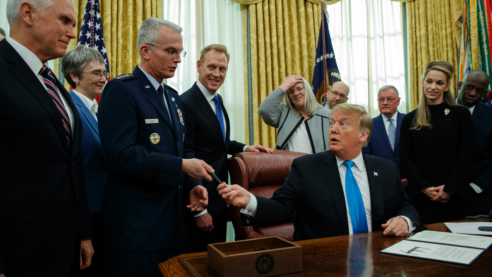 President Donald Trump hands a pen to Air Force Gen. Paul Selva after signing "Space Policy Directive 4" in the Oval Office of the White House, Tuesday, Feb. 19, 2019, in Washington. (AP Photo/ Evan Vucci)