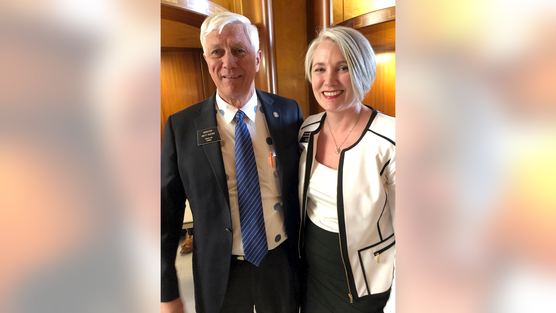 Sen. Jim Roers, left, and his daughter, Rep. Shannon Roers Jones, pose for a photo at the state Capitol in Bismarck, North Dakota, Tuesday, March 19, 2019. Roers Jones of Fargo pushed successful legislation to repeal the state's longstanding Sunday business restrictions that are rooted in religious tradition. Jim Roers voted against the repeal in 2017 but changed his mind after pressure from constituents and his daughter. (AP Photo/James MacPherson)
