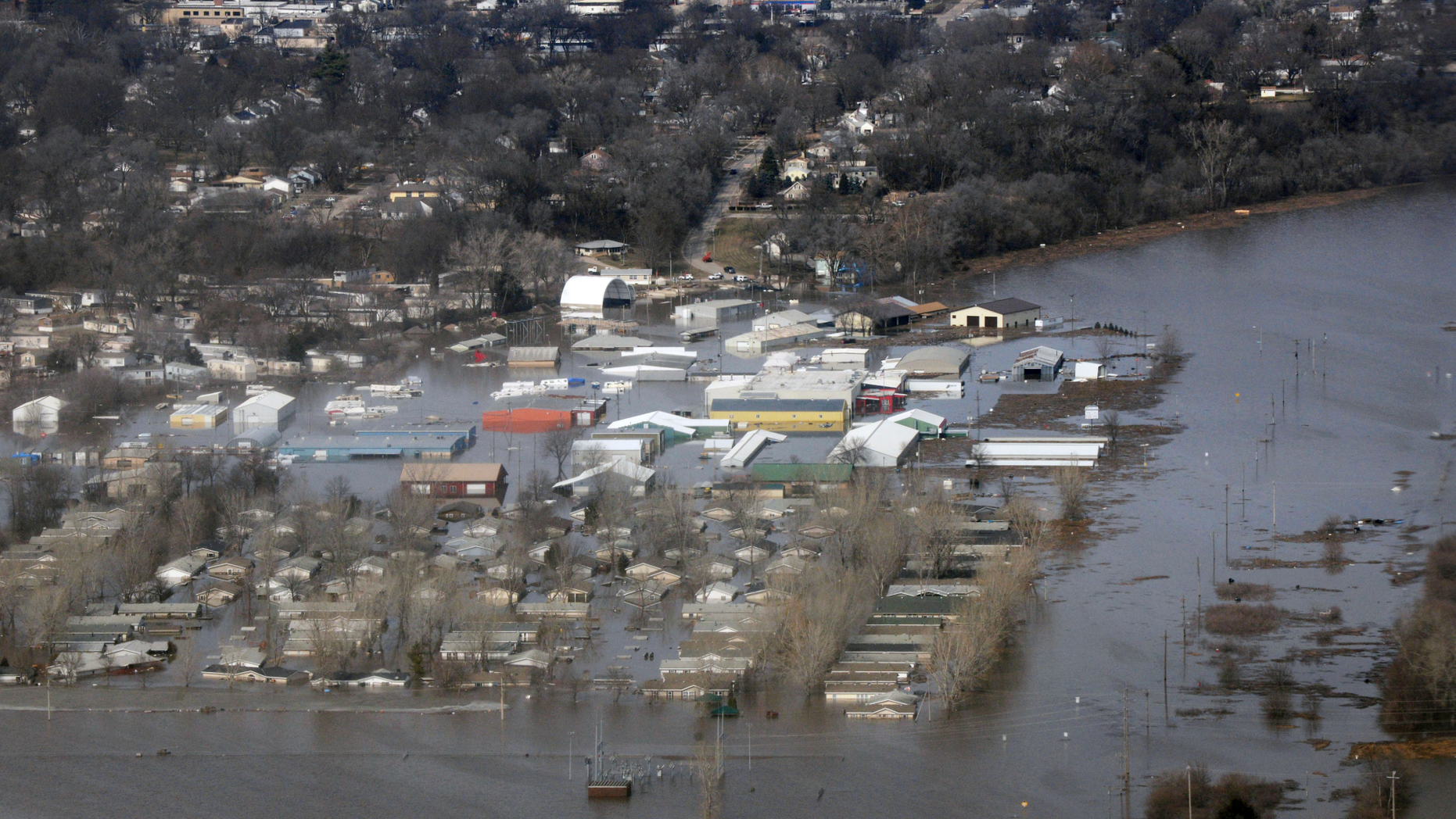This March 17, 2019 photo released by the U.S. Air Force shows an aerial view of Areas surrounding Offutt Air Force Base affected by flood waters in Neb. Surging unexpectedly strong and up to 7 feet high, the Missouri River floodwaters that poured on to much the Nebraska air base that houses the U.S. Strategic Command overwhelmed the frantic sandbagging by troops and their scramble to save sensitive equipment, munitions and aircraft. (Tech. Sgt. Rachelle Blake/The U.S. Air Force via AP)