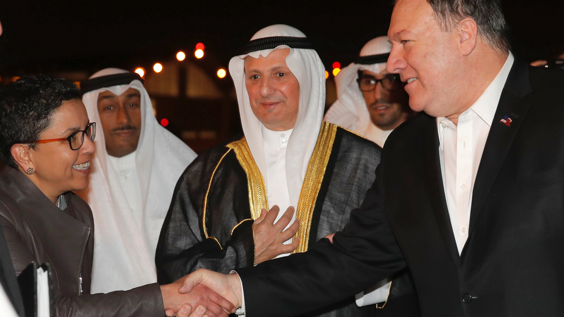 U.S. Secretary of State Mike Pompeo shakes hands with Ambassador Reem Al-Khaled, as he arrives at Kuwait International Airport in Kuwait City, Kuwait, Tuesday, March 19, 2019. (Jim Young/Pool Image via AP)