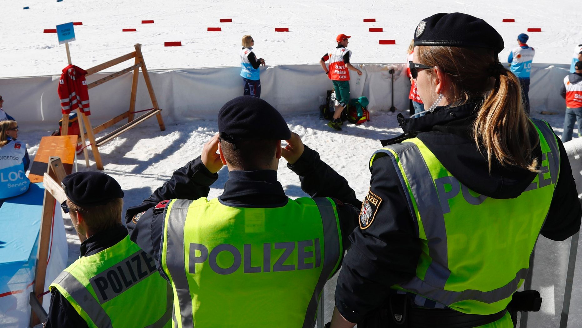 Austrian Federal Police officers stand at the finish area of a men's cross country skiing 15km classic competition, at the Nordic Ski World Championships, in Seefeld, Austria, Wednesday, Feb. 27, 2019. Austrian authorities say five elite athletes and four others have been arrested in doping raids in the country and neighboring Germany amid the Nordic skiing world championships. (AP Photo/Matthias Schrader)