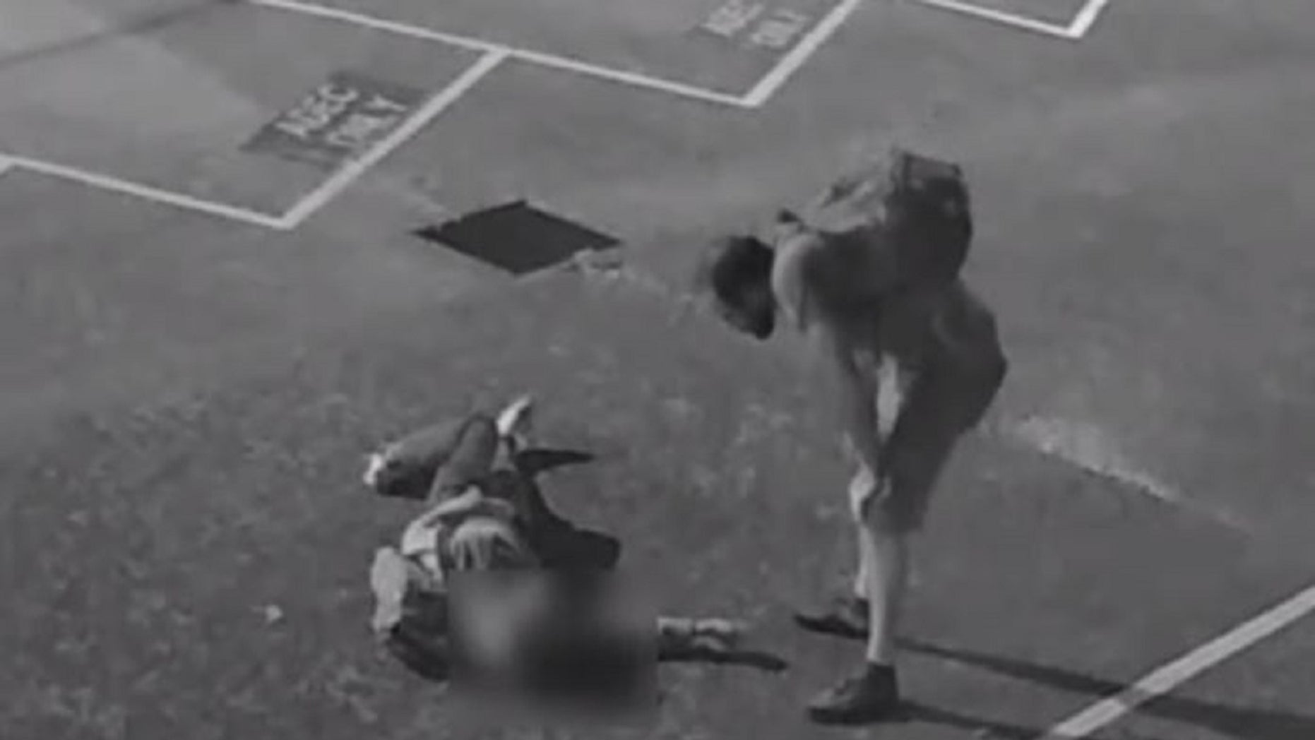 A screen capture from surveillance video shows a suspect standing over an unidentified American tourist who was badly beaten in Australia, according to police.