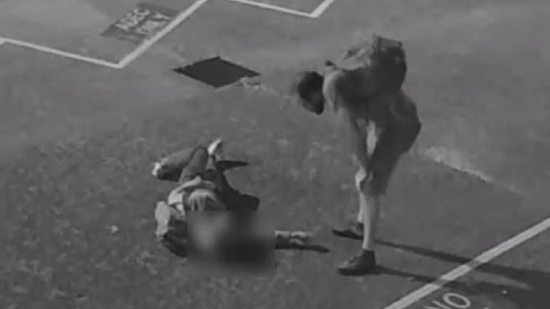 A screen capture from surveillance video shows a suspect standing over an unidentified American tourist who was badly beaten in Australia, according to police.