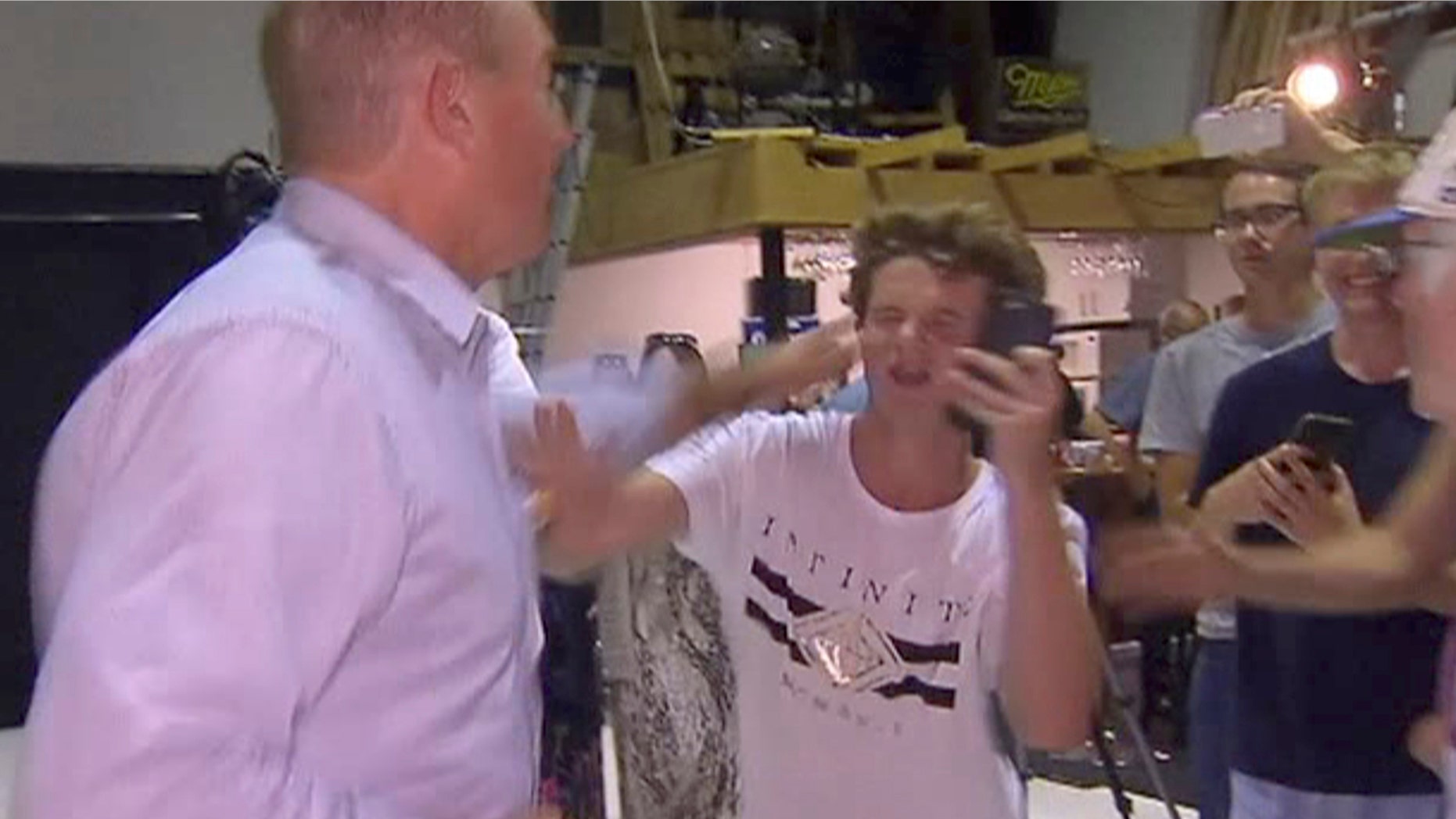 In this image made from video, Senator Fraser Anning swipes at a teenager who broke an egg on his head while he was holding a press conference, Saturday, March 16, 2019, in Melbourne, New Zealand. Following the mass shootings on Friday, Anning came under sharp criticism over tweets including one that said: “Does anyone still dispute the link between Muslim immigration and violence?” (AP Photo)