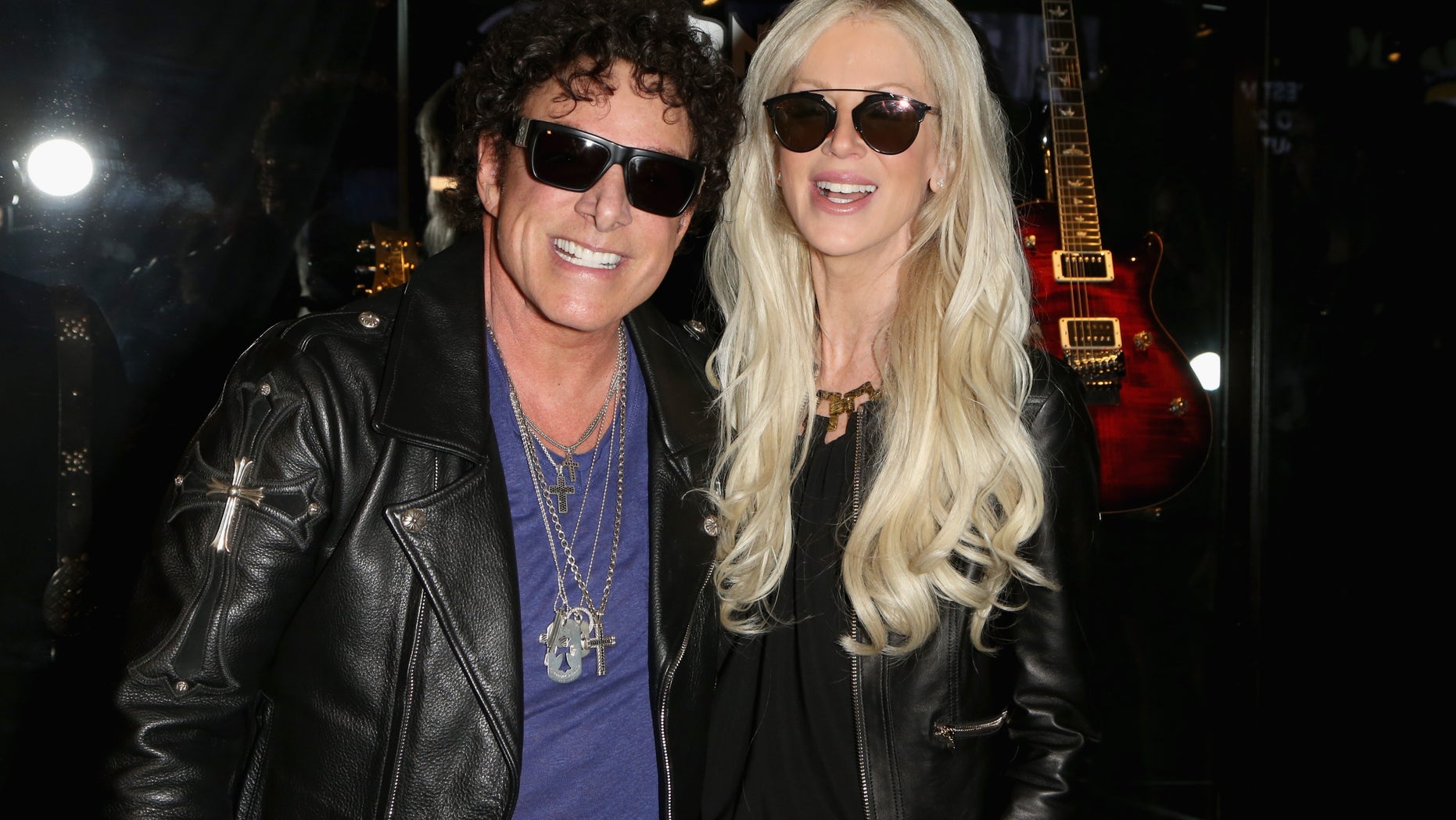 Guitarist Neal Schon (L) of Journey and his wife, television personality Michaele Schon are reportedly suing Live Nation for emotional distress.