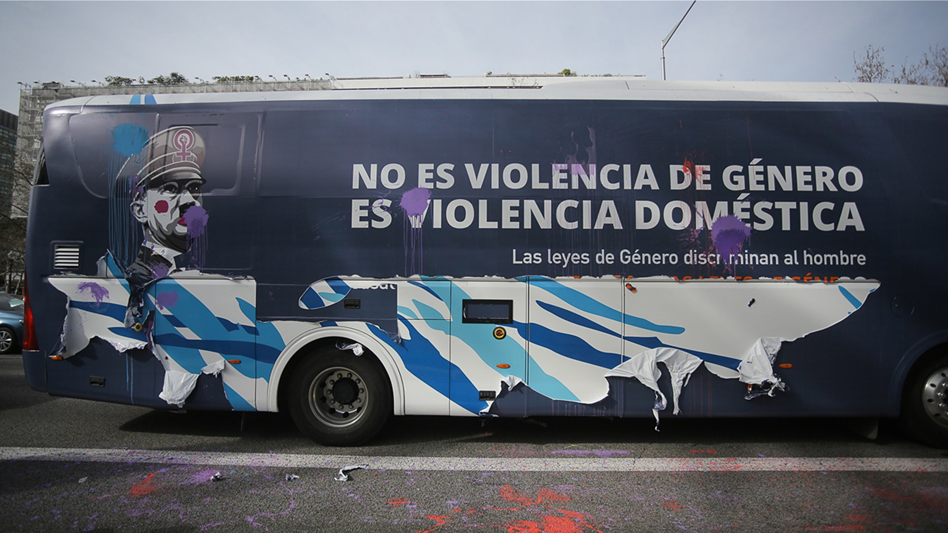A bus chartered by conservative association "Hazte Oir" (Make yourself heard) displaying an image of the leader of the Nazi Party, Adolf Hitler with make-up on his face and sporting a feminist symbol on his hat, next to a legend reading "It is not gender violence, it is domestic violence" in Barcelona on March 4, 2019, after protesters threw paint to it and peeled off part of its vinyl decoration.