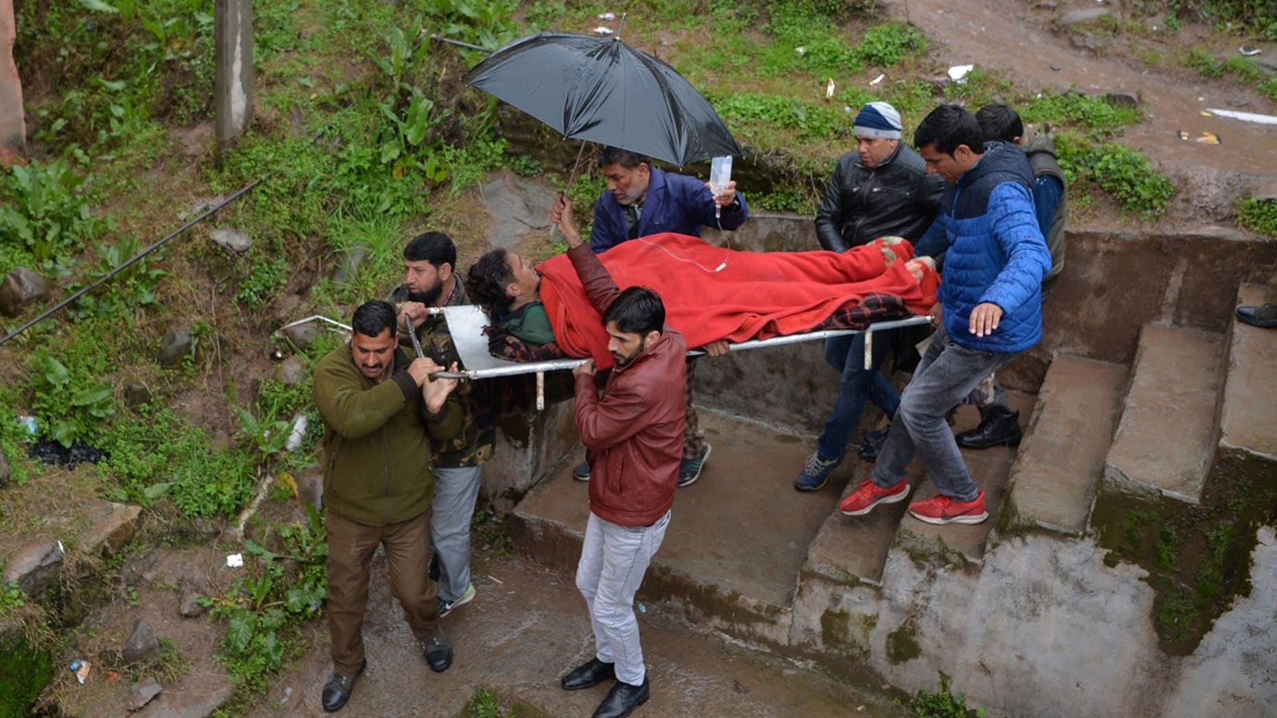 An injured man is carried on a stretcher at a hospital in the Indian Kashmir frontier town of Mendhar on March 2, 2019, after being wounded in his home when it was struck by a mortar shell that his family said was fired by Pakistan troops along the Line of Control (LoC) that divides Kashmir between India and Pakistan