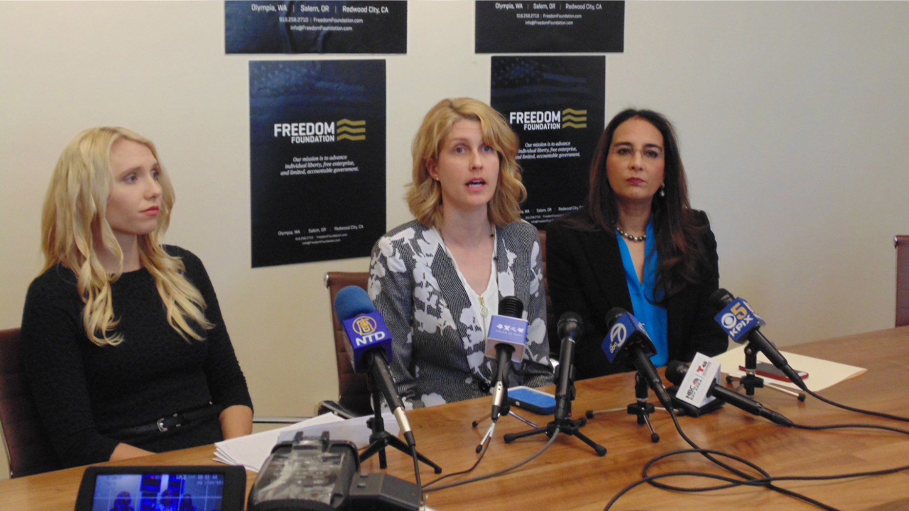 Bethany Mendez, center, along with attorney Harmeet K. Dhillon, right and Mariah Gondeiro-Watt, litigation counsel for the Freedom Foundation, at a press conference on Monday.