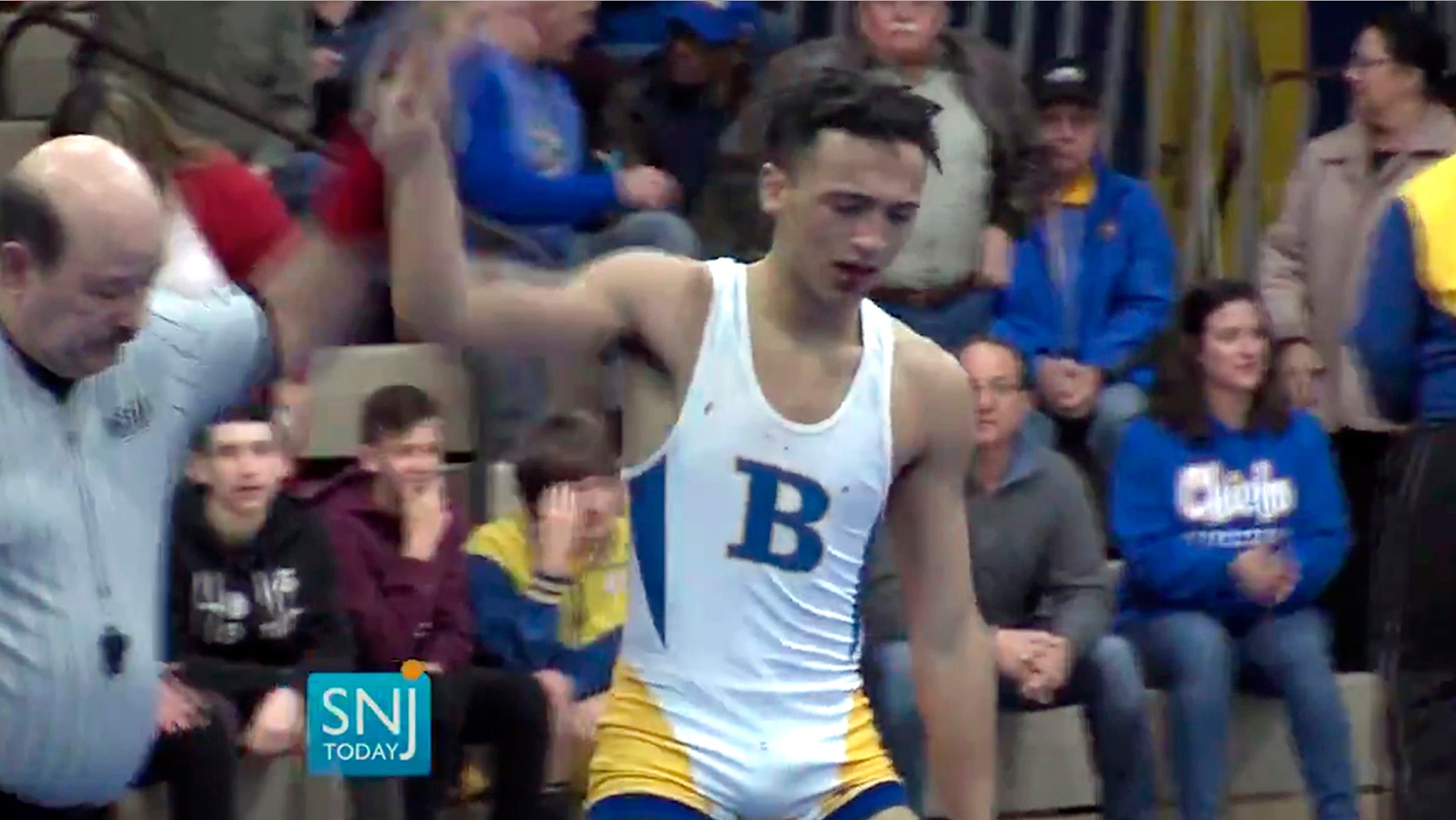 In this Wednesday, Dec. 19, 2018 image made from video provided by SNJTODAY.COM, Buena Regional High School wrestler Andrew Johnson is declared the winner by referee Alan Maloney after a match in Buena, N.J.