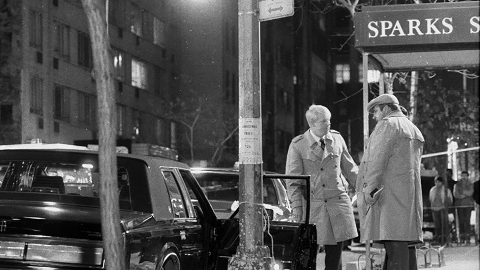 Detectives stand on the body of renowned mafia boss Paul Castellano, after his execution on 46th Street in December 1985 (Photo: Tom Monaster / The New York Daily via Getty Images)