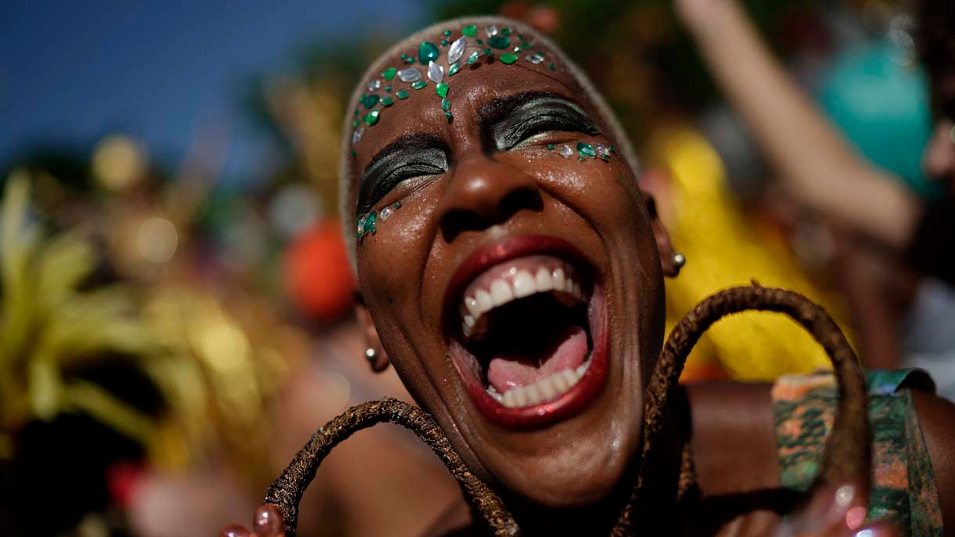 A reveler in costume laughs during the "Cordao do Boitata" street party in Rio de Janeiro, Brazil, Sunday, Feb. 24, 2019, one of the many parades before the official start of Carnival on March 1. (AP Photo/Leo Correa)