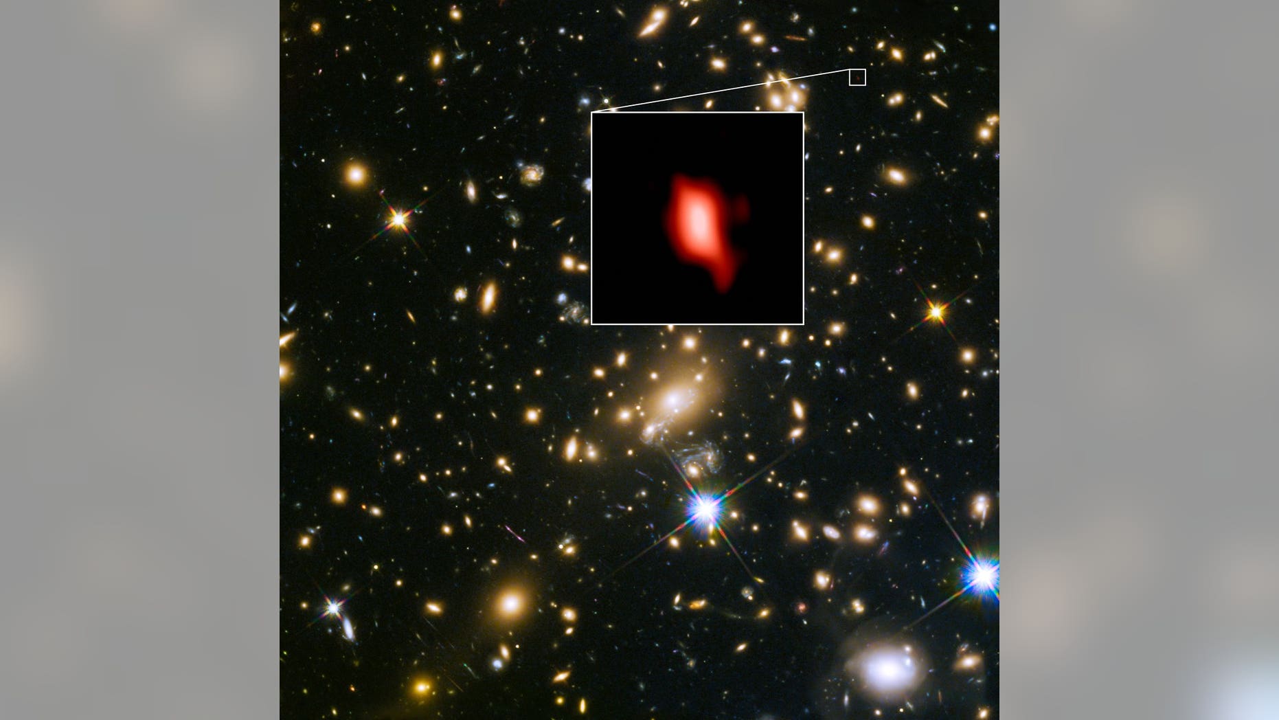 The distant galaxy MACS1149-JD1, shown in the insert, appears as it was 13.3 billion years ago, only 500 million years after the Big Bang. Oxygen distribution detected by ALMA appears in red.