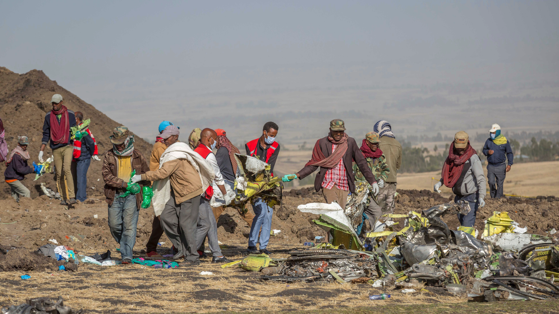 Rescuers work at the scene of an Ethiopian Airlines flight crash near Bishoftu, or Debre Zeit, south of Addis Ababa, Ethiopia, Monday, March 11, 2019. A spokesman says Ethiopian Airlines has grounded all its Boeing 737 Max 8 aircraft as a safety precaution, following the crash of one of its planes in which 157 people were killed. (AP Photo/Mulugeta Ayene)