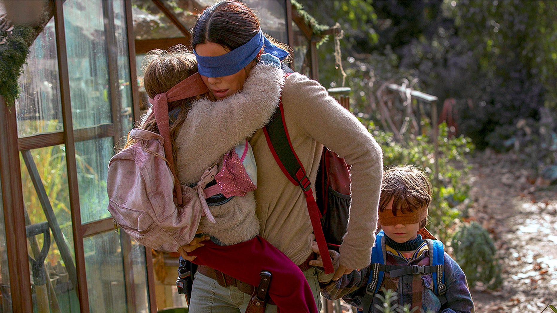 This image released by Netflix shows Sandra Bullock in a scene from the film, "Bird Box." Netflix will remove footage of a real fiery train disaster from its hit post-apocalyptic survival film "Bird Box" months after the streaming giant was criticized for exploiting a tragedy. The stock footage was taken from a 2013 crash in the Quebec town of Lac-Megantic when a train carrying crude oil came off the tracks and exploded into a massive ball of fire, killing 47 people. (Saeed Adyani/Netflix via AP)