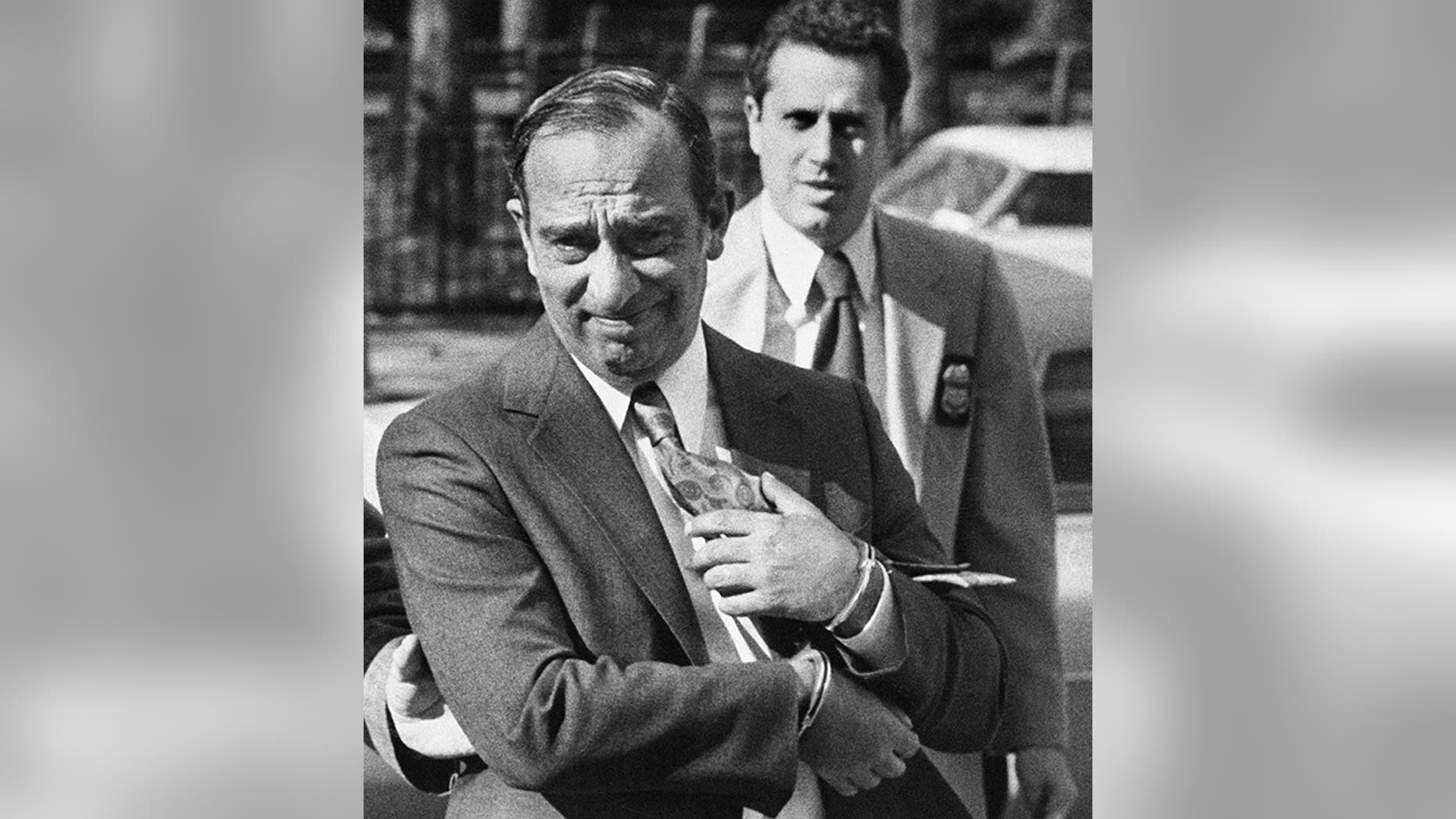 Photo shows Colombo crime family boss Carmine Persico as he was led into court in handcuffs in New York in 1980. (New York Post via AP)