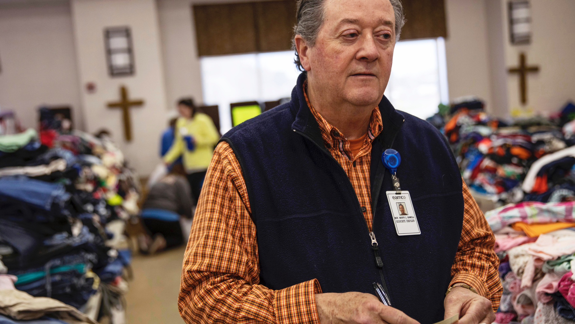 In this Wednesday, March 6, 2019 photo, Rusty Sowell, pastor at Providence Baptist Church, speaks to volunteers organizing donations at the church in Beauregard, Ala. Dealing with the dead became a huge task in a rural Alabama community where nearly two dozen people died in a tornado outbreak. The county coroner, Bill Harris, set up a temporary command post and performed post-mortem exams. He and Sowell then held 17 separate meetings with relatives of the 23 people who died. (AP Photo/David Goldman)
