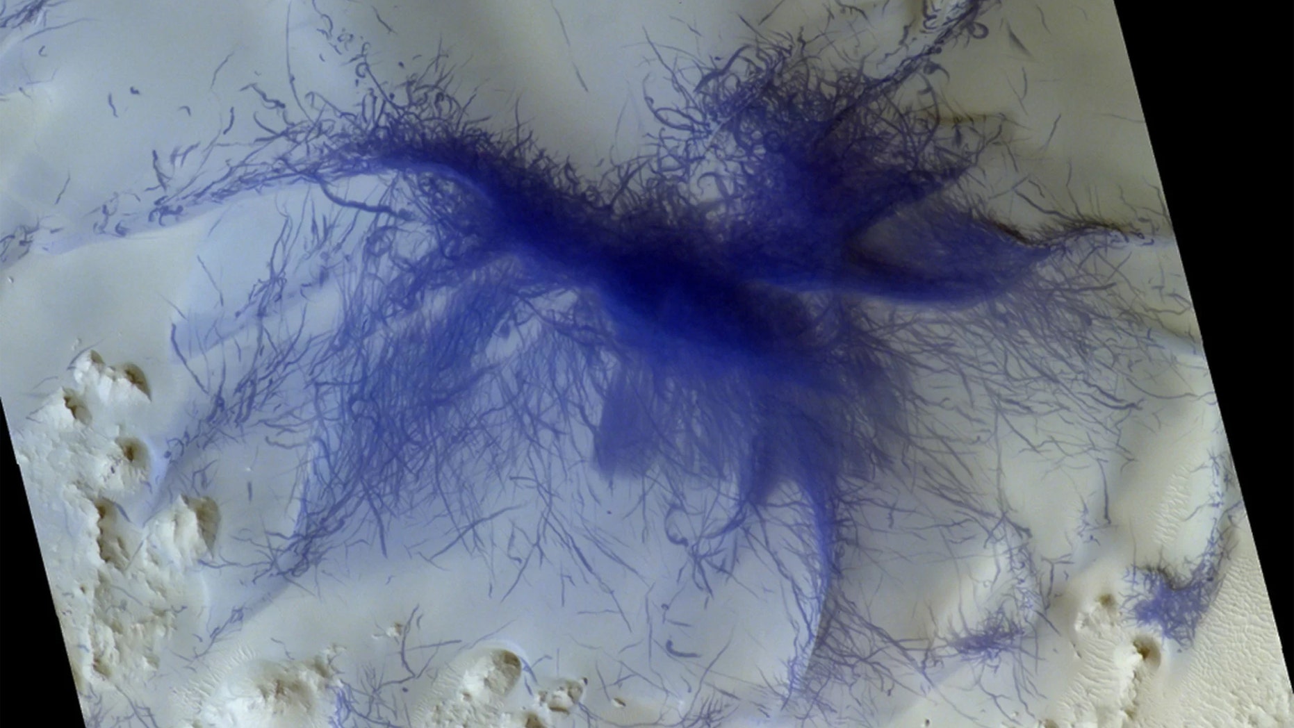 A feature on Mars that looks like a very hairy spider was likely caused by the convergence of hundreds or even thousands of tornadoes. (Credit: ESA/Roscosmos/CaSSIS, CC BY-SA 3.0 IGO)