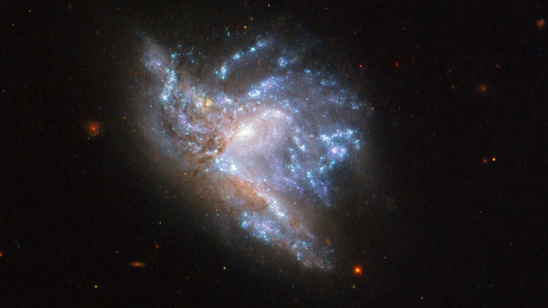 Located in the constellation of Hercules, about 230 million light-years away, NGC 6052 is a pair of colliding galaxies. They were first discovered in 1784 by William Herschel and were originally classified as a single irregular galaxy because of their odd shape.