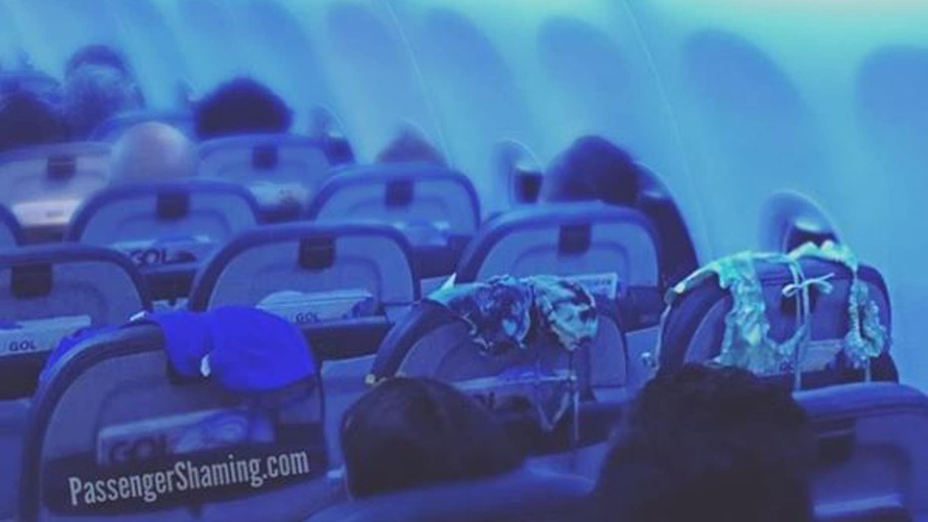 A passenger was caught using the back of three seats to air out three different swimsuits.
