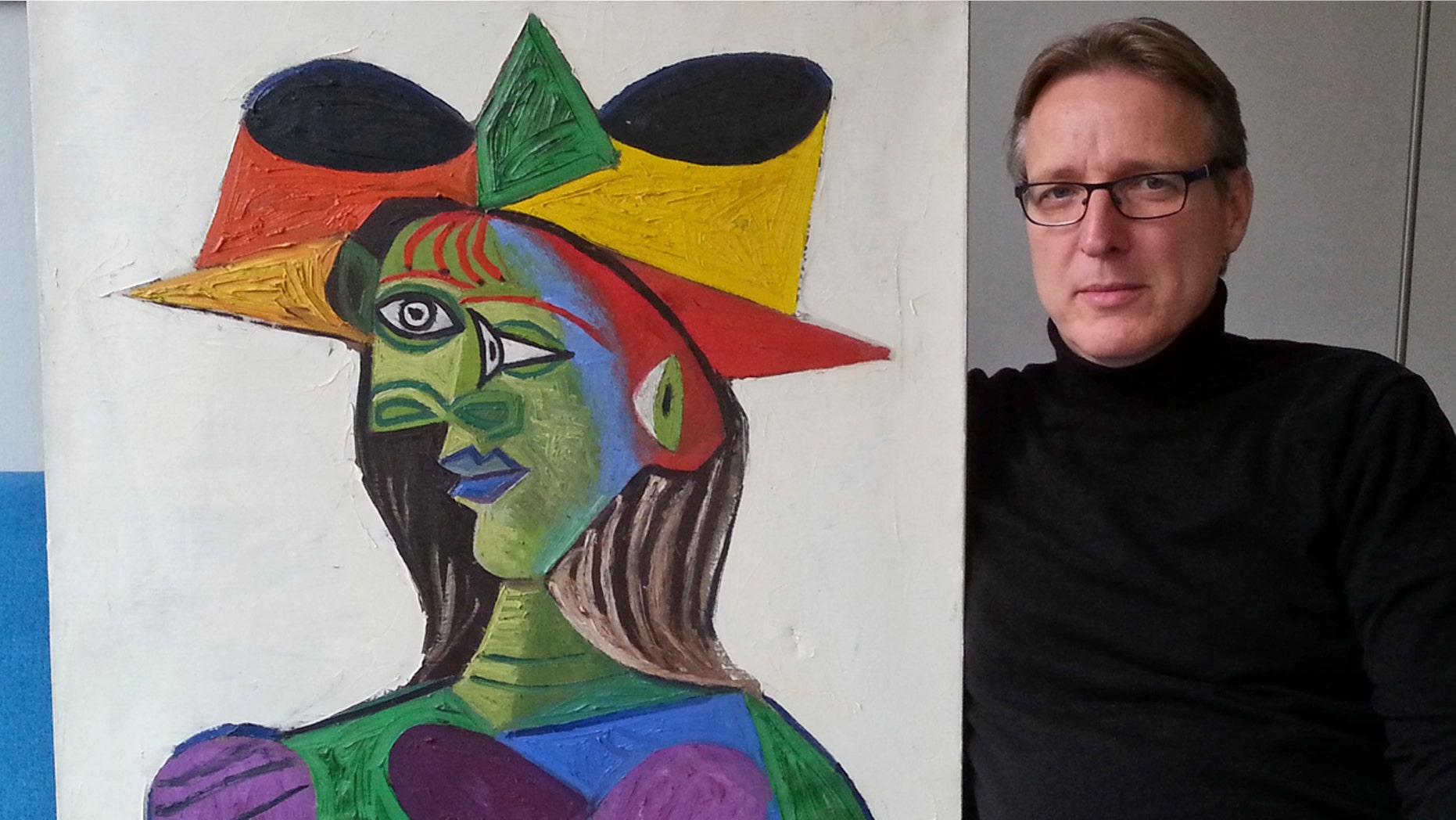This image released on Tuesday March 26, 2019 by Arthur Brand, shows Dutch art detective Arthur Brand with "Buste de Femme", a recovered Picasso painting.