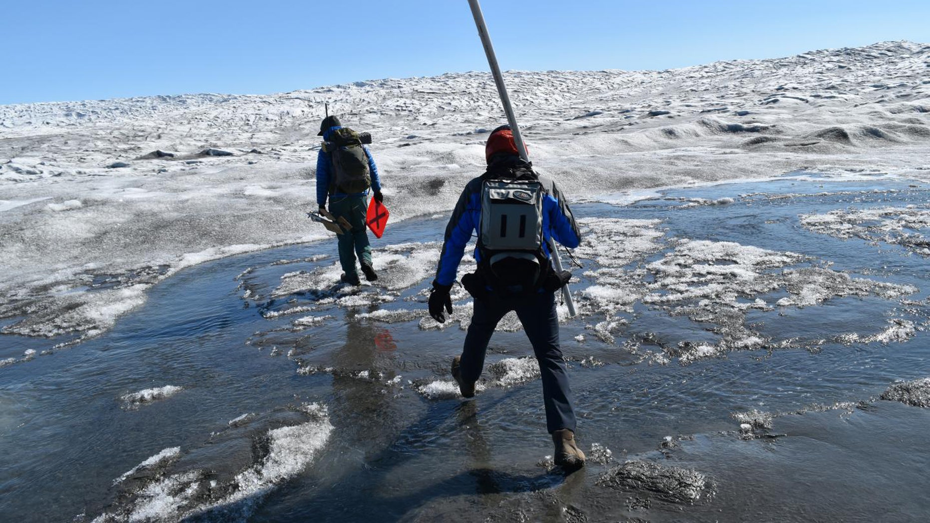 Increasing rainfall over the Greenland ice sheet is driving rapid melting of the surface. Here, researchers cross Greenland's Russell Glacier, July 2018. (Credit: Kevin Krajick/Earth Institute)