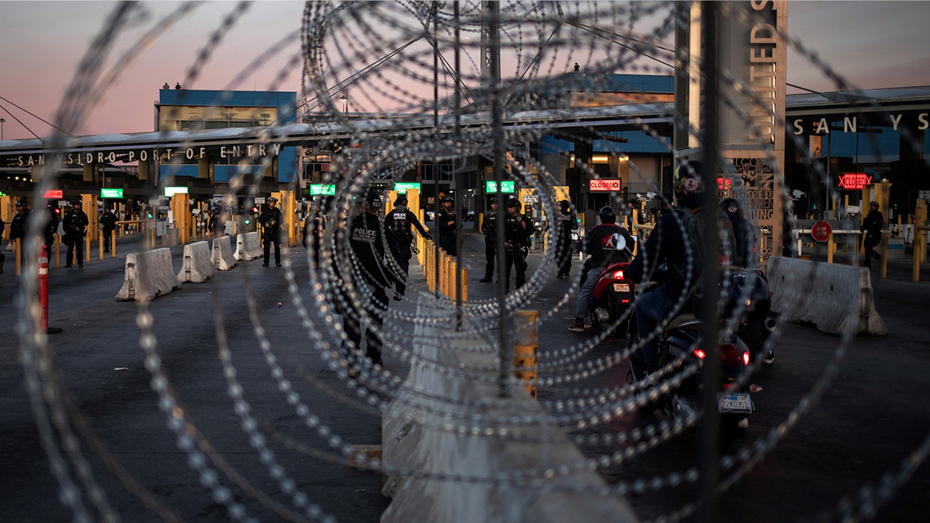 U.S. Customs and Border Protection Special Response Team officers are seen through concertina wire after the San Ysidro Port of Entry land border crossing was temporarily closed to traffic in Tijuana, Mexico in November.
