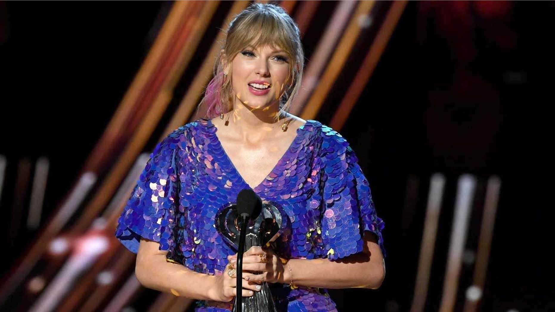 Taylor Swift accepts the Tour of the Year honor at the 2019 iHeartRadio Music Awards.