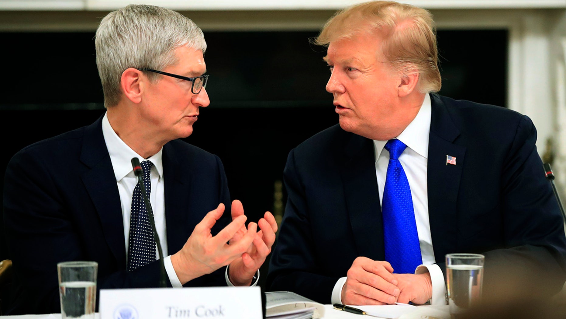 President Donald Trump talks to Apple Inc. CEO Tim Cook during the American Workforce Policy Advisory Board's first meeting in the State Dining Room of the White House in Washington, Wednesday, March 6, 2019. (AP Photo/Manuel Balce Ceneta)