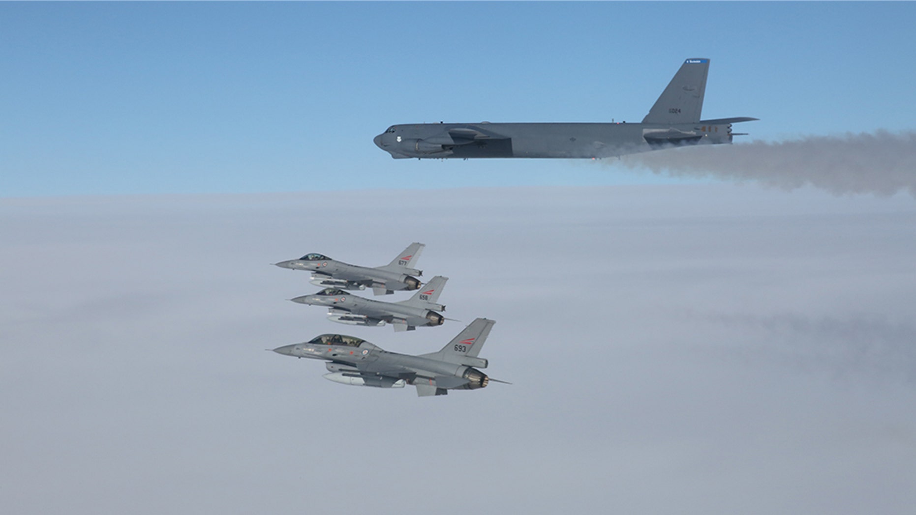 A U.S. B-52 Stratofortresses, deployed from Barksdale Air Force Base, La., flies in formation with three Norwegian F-16 Fighting Falcons over Norway, March 28, 2019.Â