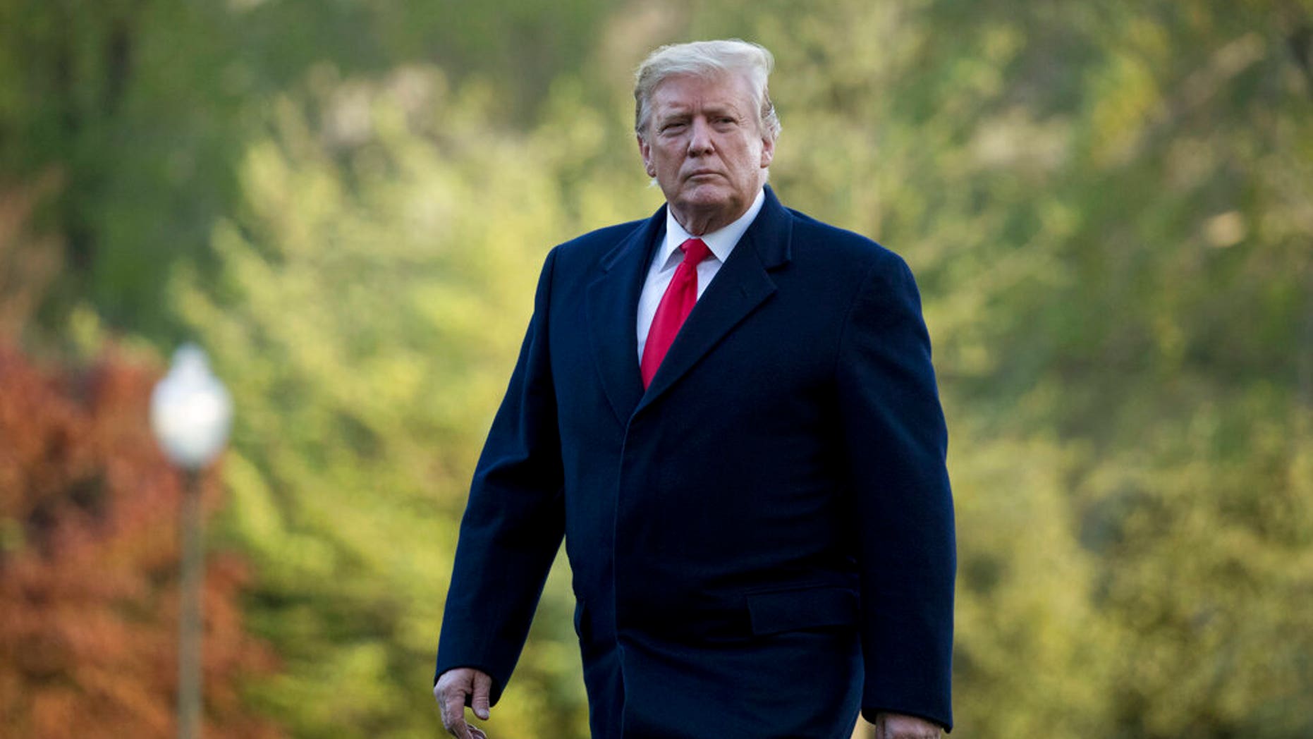 FILE: President Donald Trump walks on the South Lawn as he arrives at the White House in Washington, after visiting Minnesota.