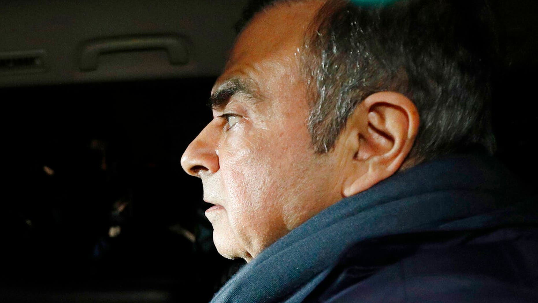 Former Nissan Chairman Carlos Ghosn in a car leaves his lawyer's office in Tokyo. 