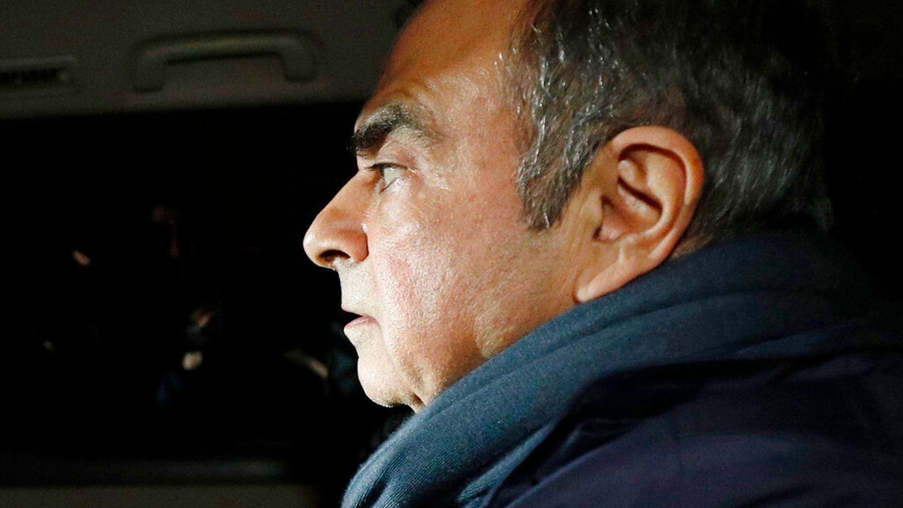Former Nissan Chairman Carlos Ghosn in a car leaves his lawyer's office in Tokyo.
