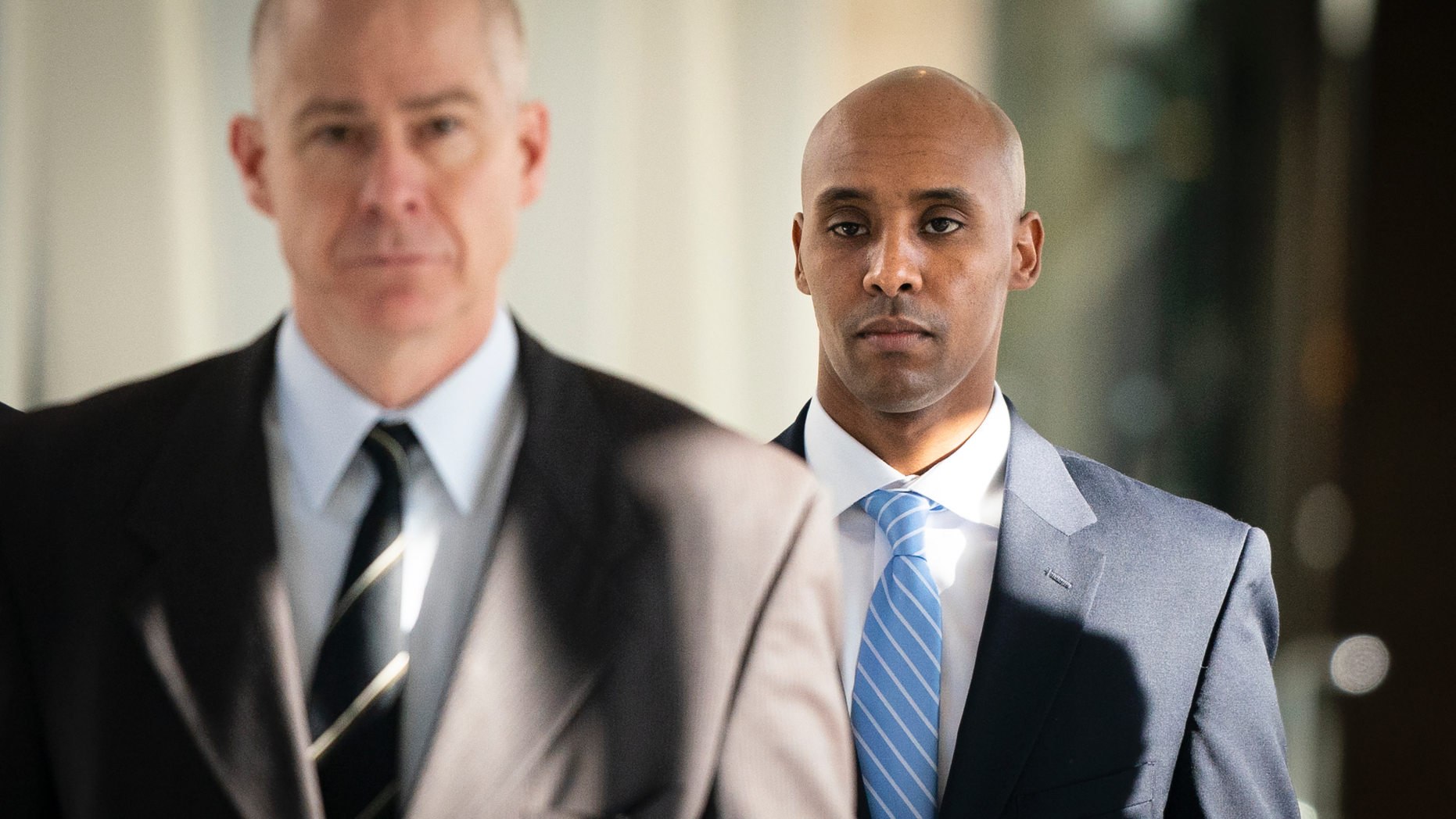 Former Minneapolis police officer Mohamed Noor walks through the skyway with his attorney Thomas Plunkett, left, on the way to court in Minneapolis on Friday, April 26, 2019. (Leila Navidi/Star Tribune via AP)