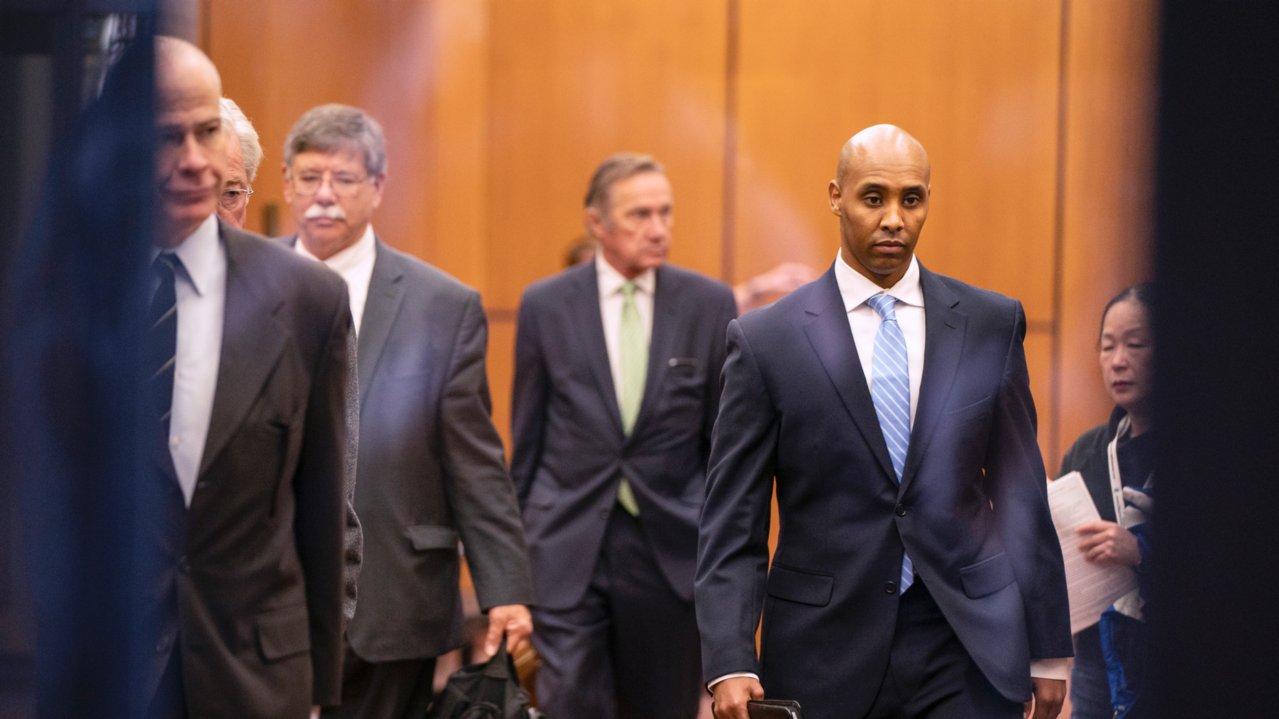 Former Minneapolis police officer, Mohamed Noor, crosses the lobby of the elevators at the Hennepin County Government Center with his team of lawyers in Minneapolis on Friday, April 26, 2019. (Leila Navidi / Star Tribune via AP )
