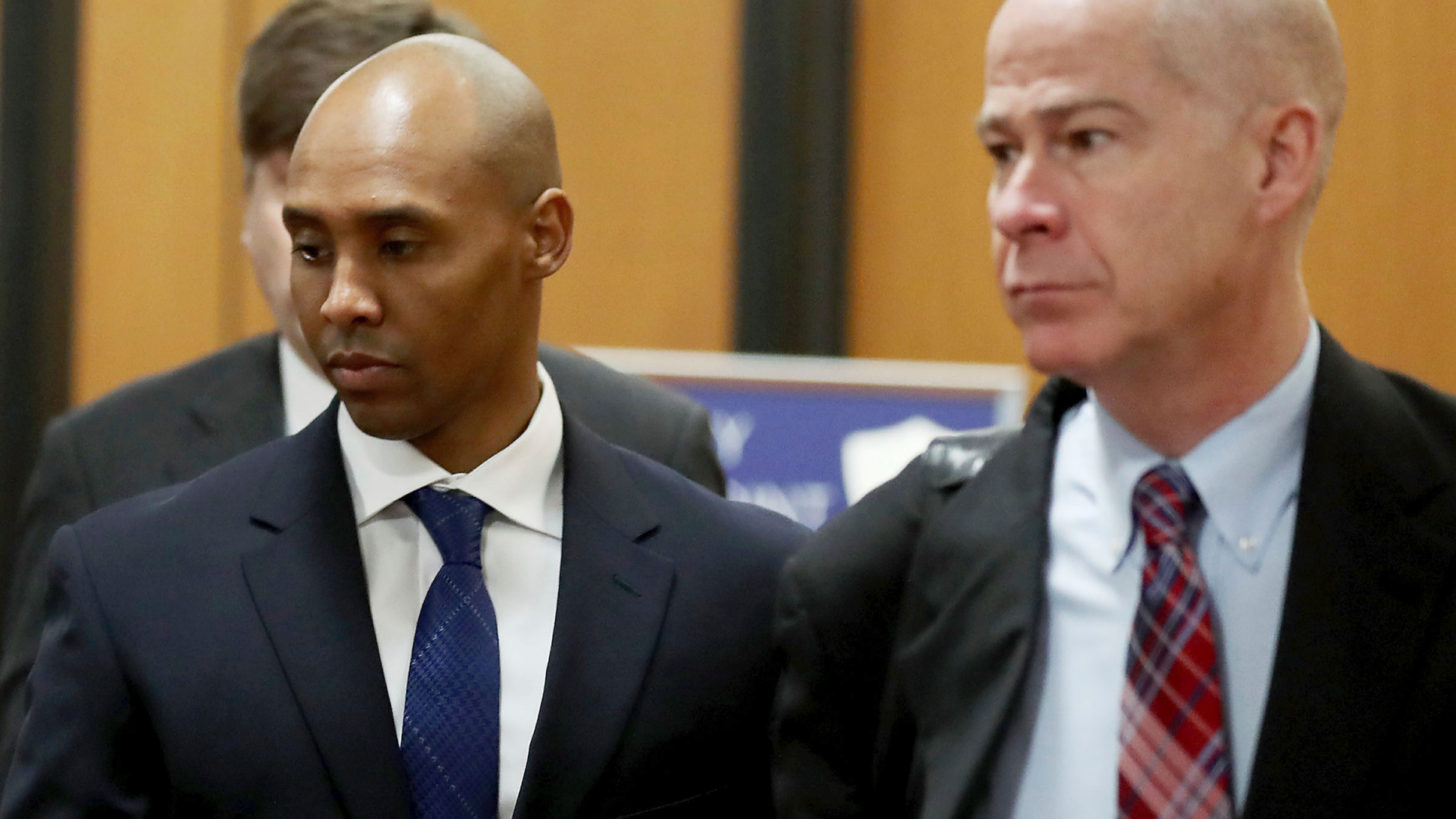 Former Minneapolis police officer Mohamed Noor, center, is accompanied by his attorneys Peter Wold, not pictured, and Thomas Plunkett, right, as he walks towards the Hennepin County Government Center for opening arguments of his trial Tuesday, April 9, 2019, in Minneapolis Opening arguments scheduled to begin in the trial of former Minneapolis police officer Mohamed Noor in the shooting death of Justine Ruszczyk Damond. (David Joles/Star Tribune via AP)