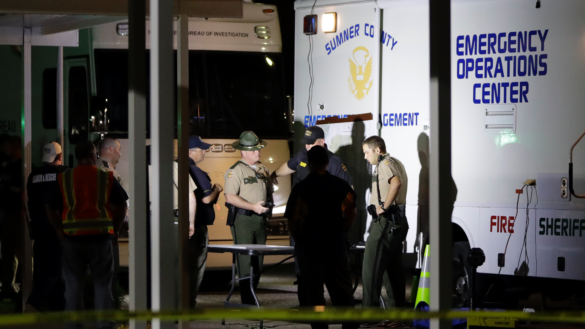 Law enforcement officials work at a command center set up at North Sumner Elementary School Saturday, April 27, 2019, in Bethpage, Tenn. Authorities in rural Tennessee captured a suspect Saturday during a manhunt that was prompted by the discovery of several bodies in two homes. (AP Photo/Mark Humphrey)