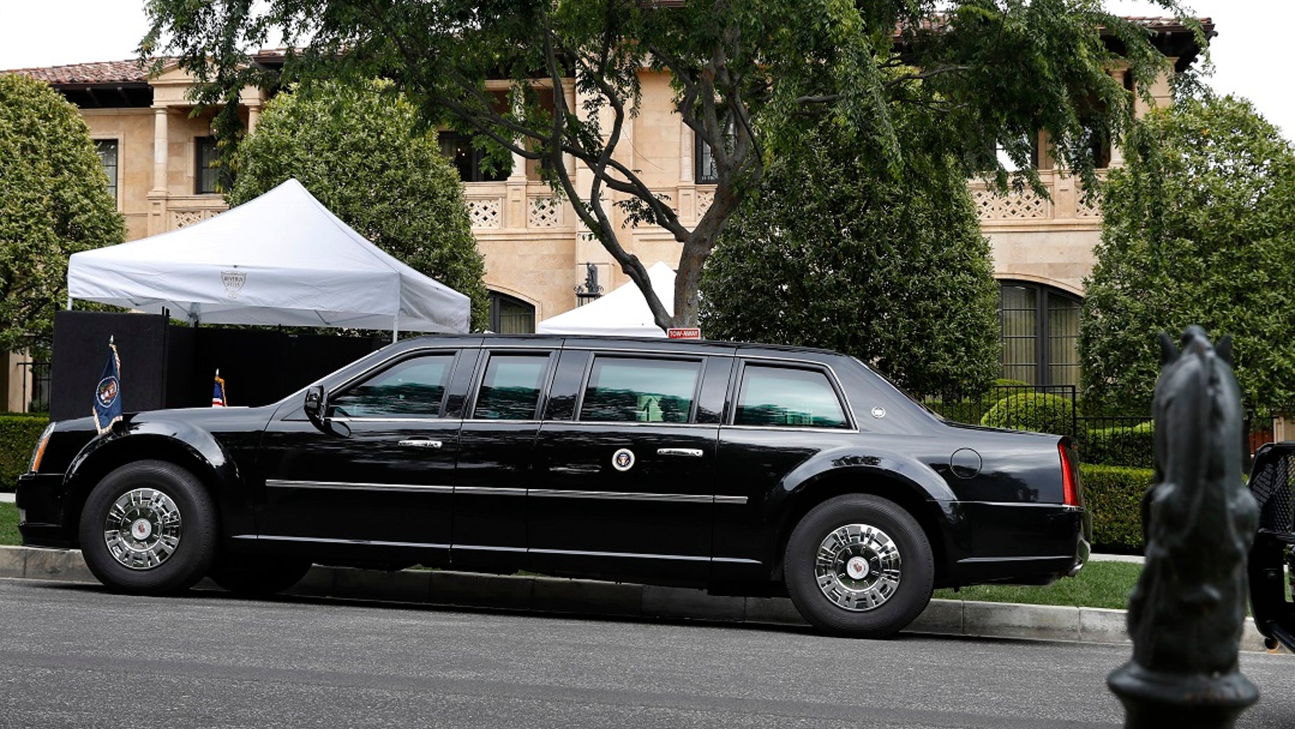 The presidential limo of President Donald Trump is parked on a hill in front of a private residence in Beverly Hills, Calif., as he meets with supporters during a fundraiser, Friday April 5, 2019. (Associated Press)