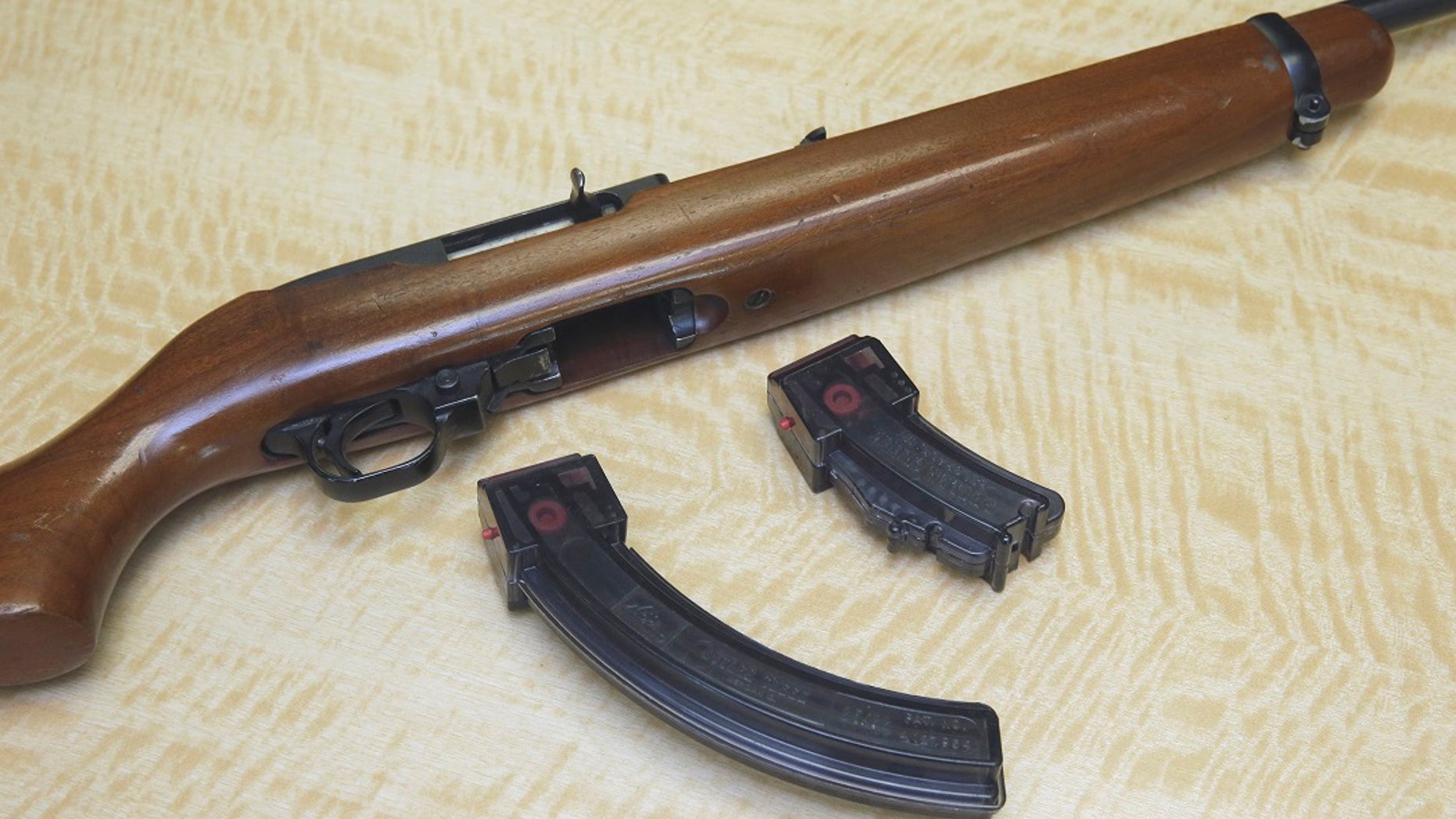 In this June 27, 2017 photo, a semi-automatic rifle is displayed with a 25 shot magazine, left, and a 10 shot magazine, right, at a gun store in Elk Grove, Calif. (Associated Press)