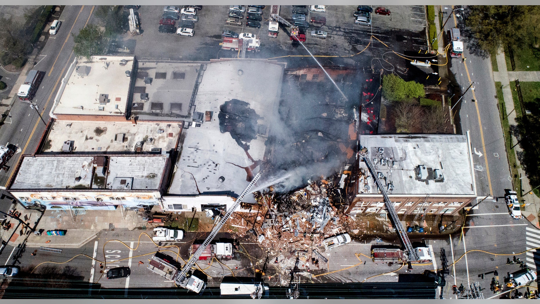 In this aerial photo, firefighters battle a fire at the scene of an explosion in Durham, N.C. Wednesday, April 10, 2019. ()